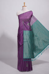Violet tussar saree with subtle silver woven motifs paired with a rich zari pallu with tassels with contrast blouse piece