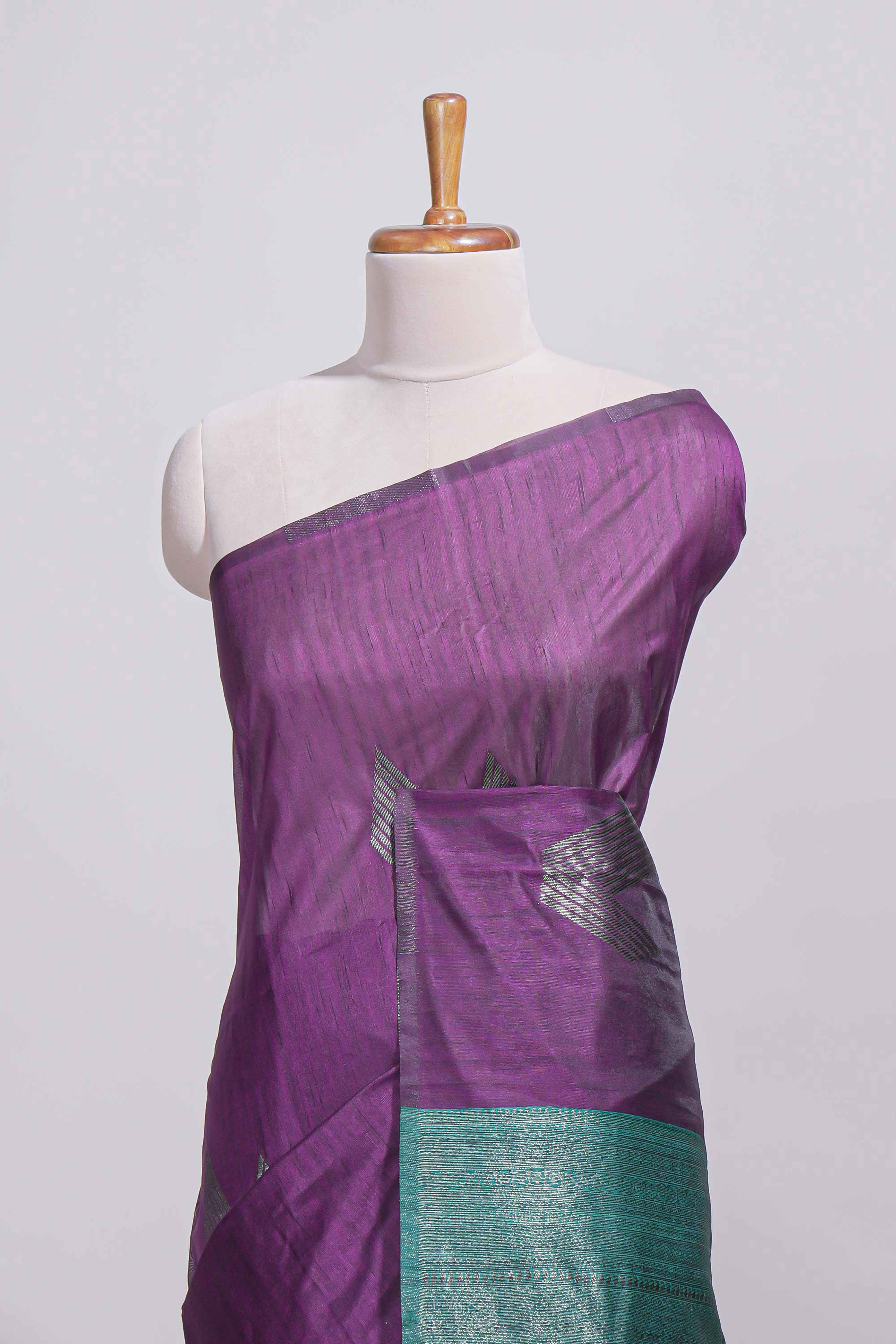 Violet tussar saree with subtle silver woven motifs paired with a rich zari pallu with tassels with contrast blouse piece