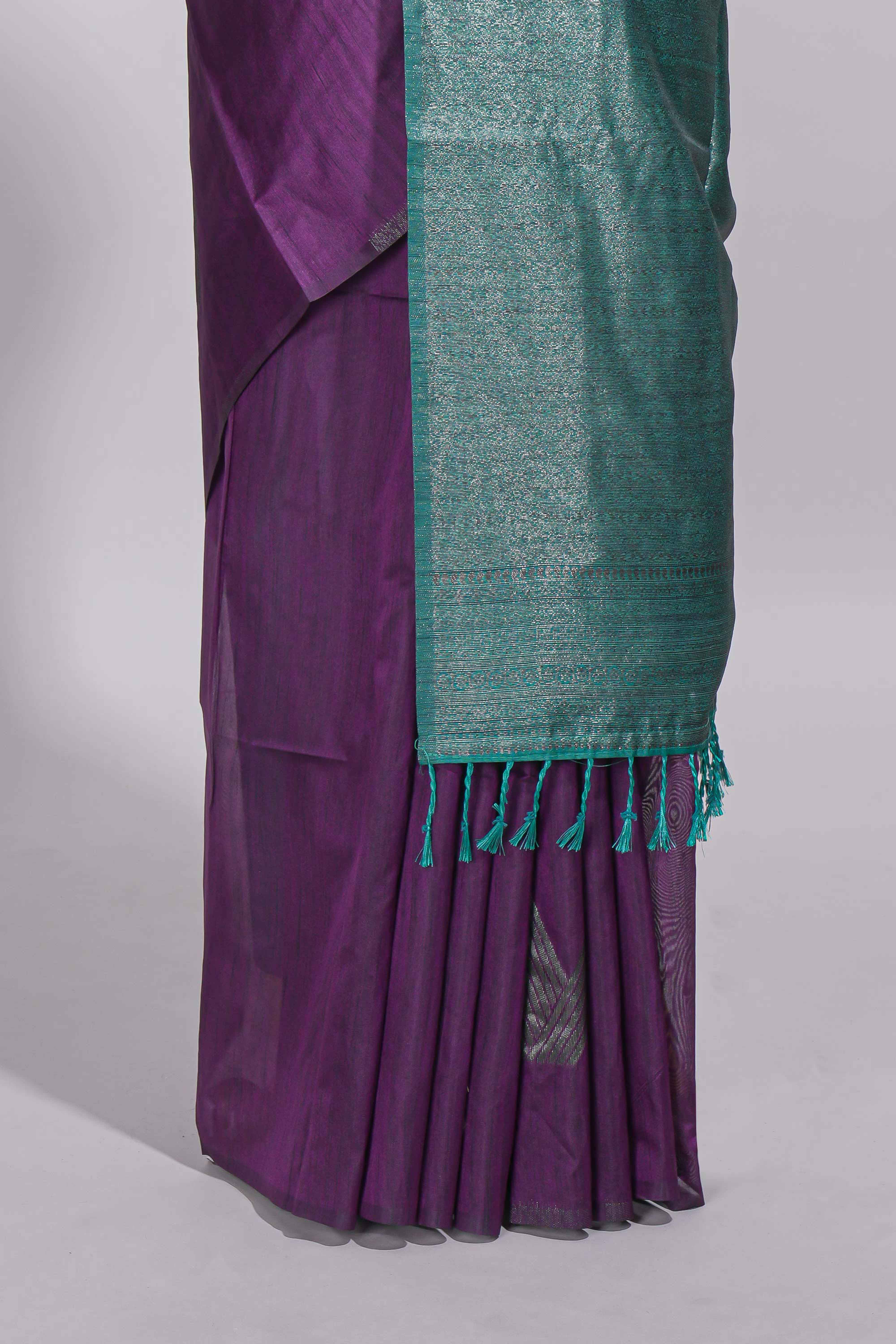 Violet tussar saree with subtle silver woven motifs paired with a rich zari pallu with tassels with contrast blouse piece