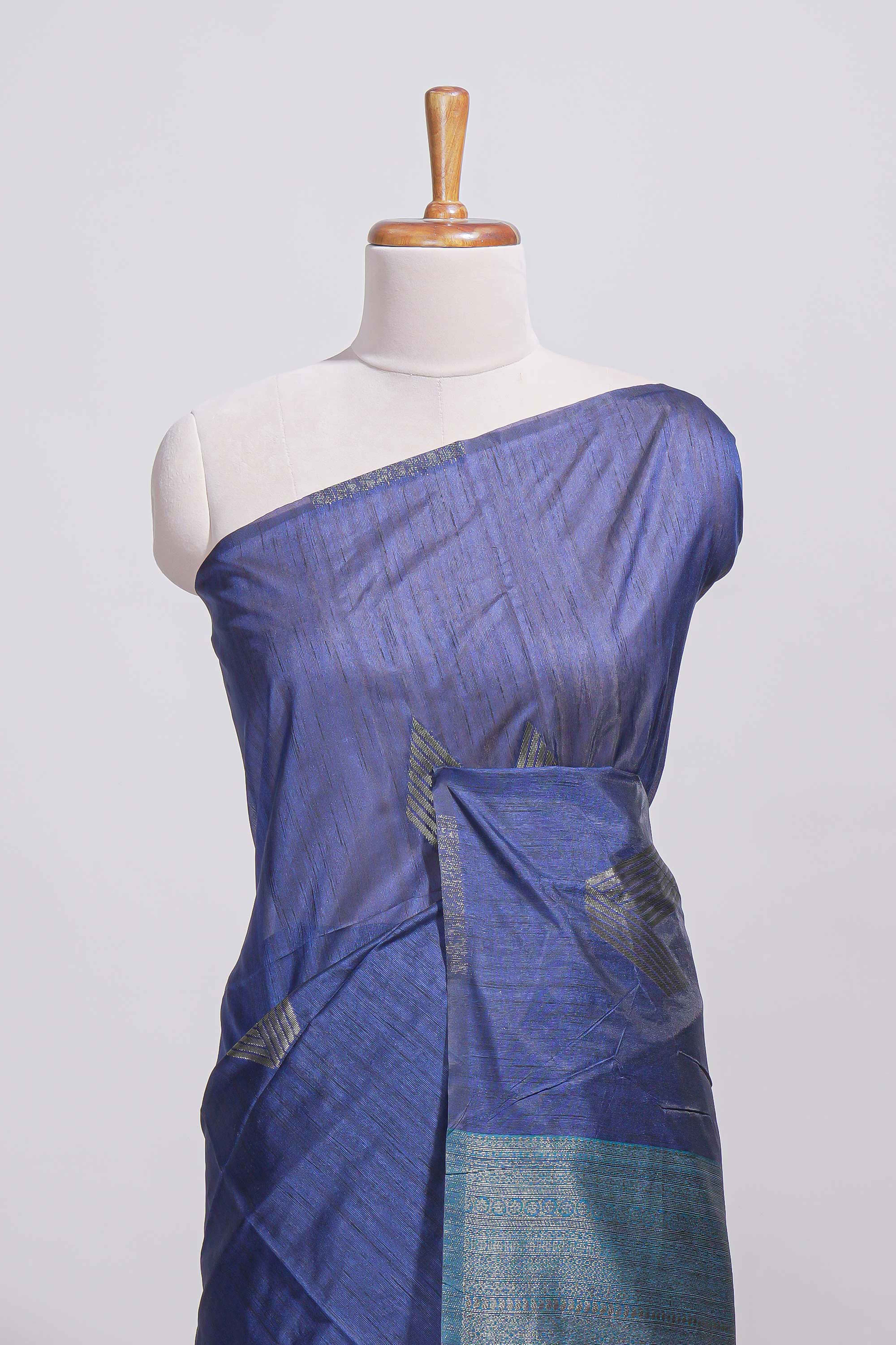 Navy blue tussar saree with subtle silver woven motifs paired with a rich zari pallu with tassels with contrast blouse piece