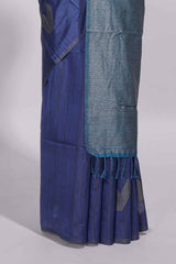 Navy blue tussar saree with subtle silver woven motifs paired with a rich zari pallu with tassels with contrast blouse piece