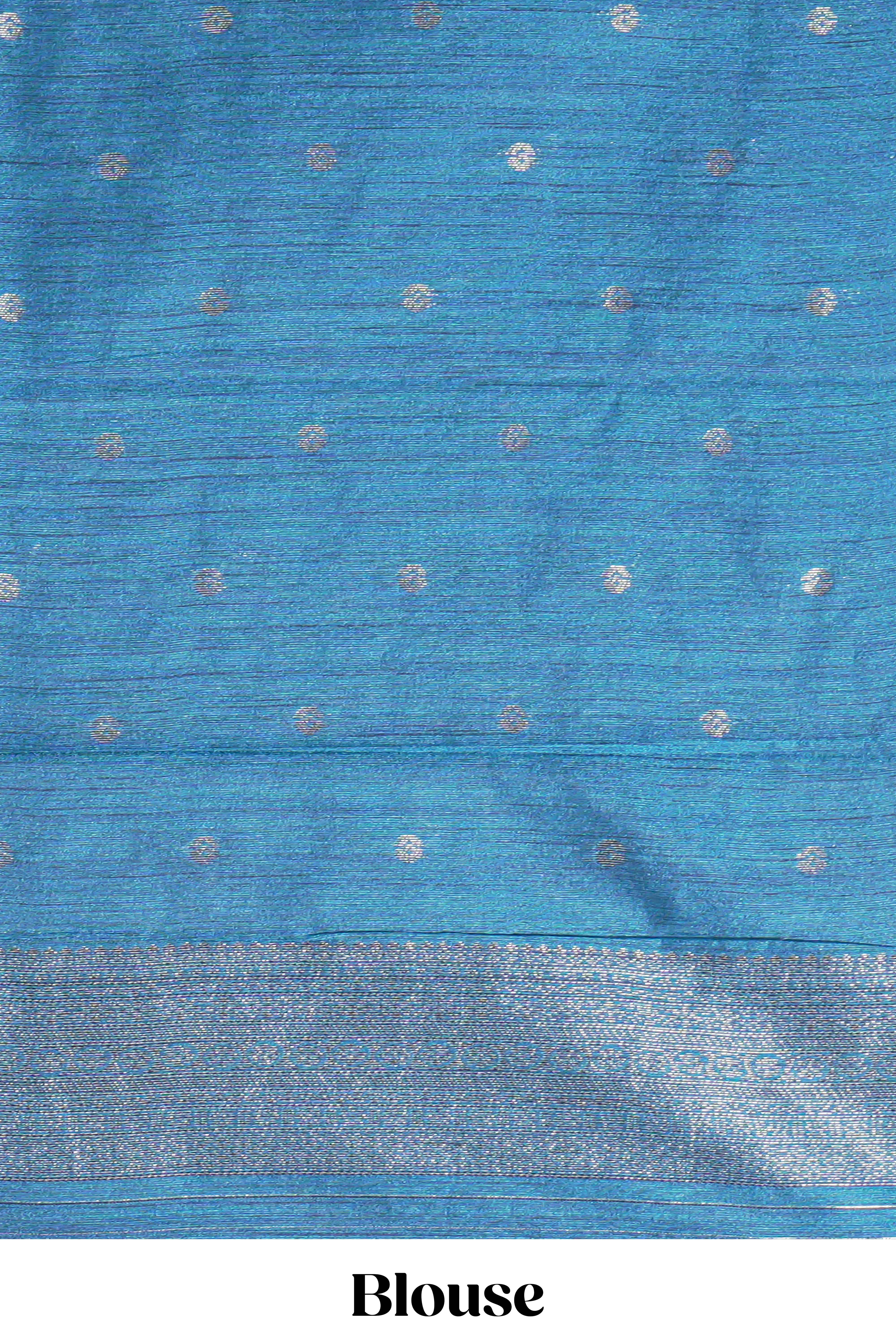 Navy blue tussar saree with subtle silver woven motifs paired with a rich zari pallu with tassels with contrast blouse piece