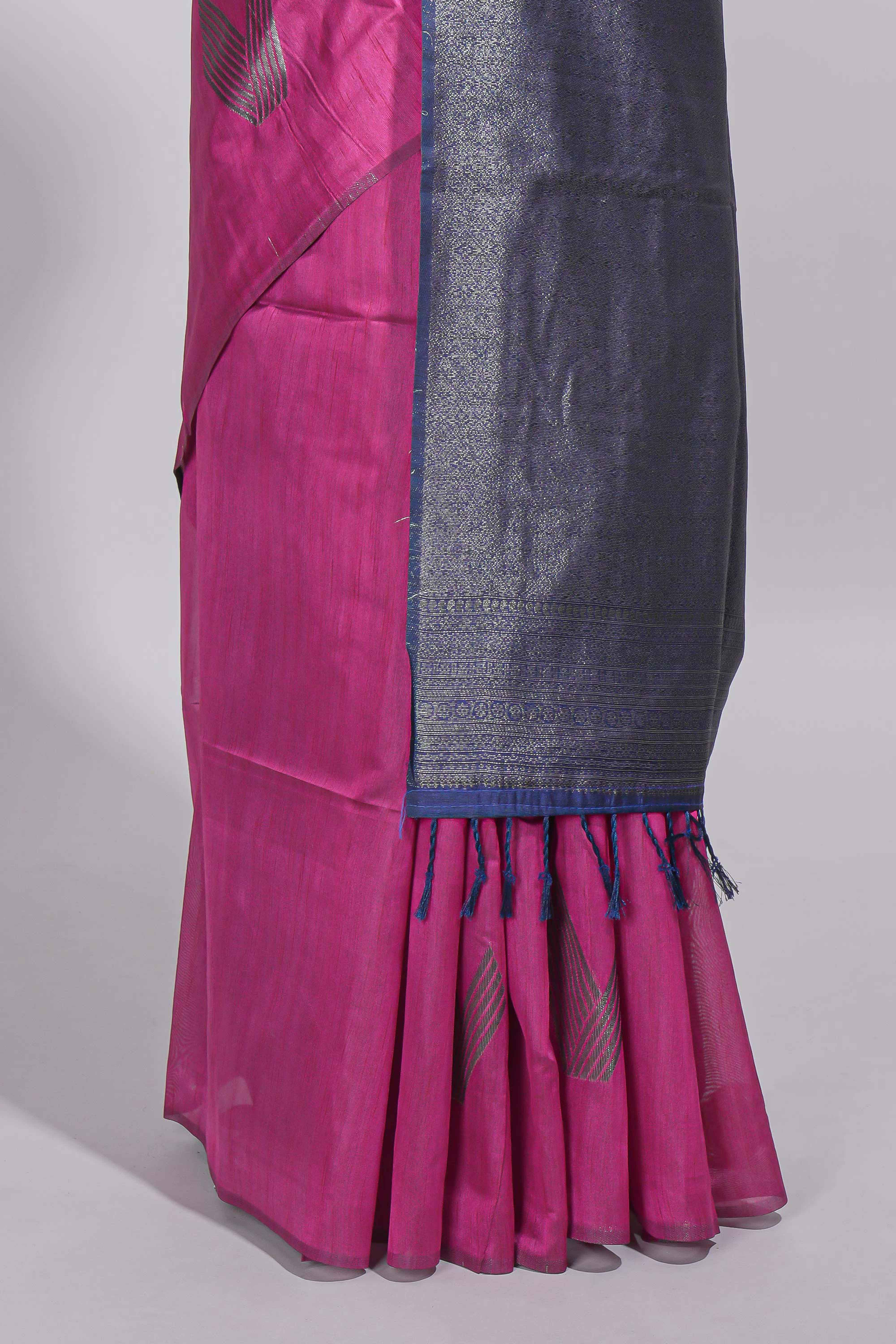 Rose color tussar saree with subtle silver woven motifs paired with a rich zari pallu with tassels with contrast blouse piece