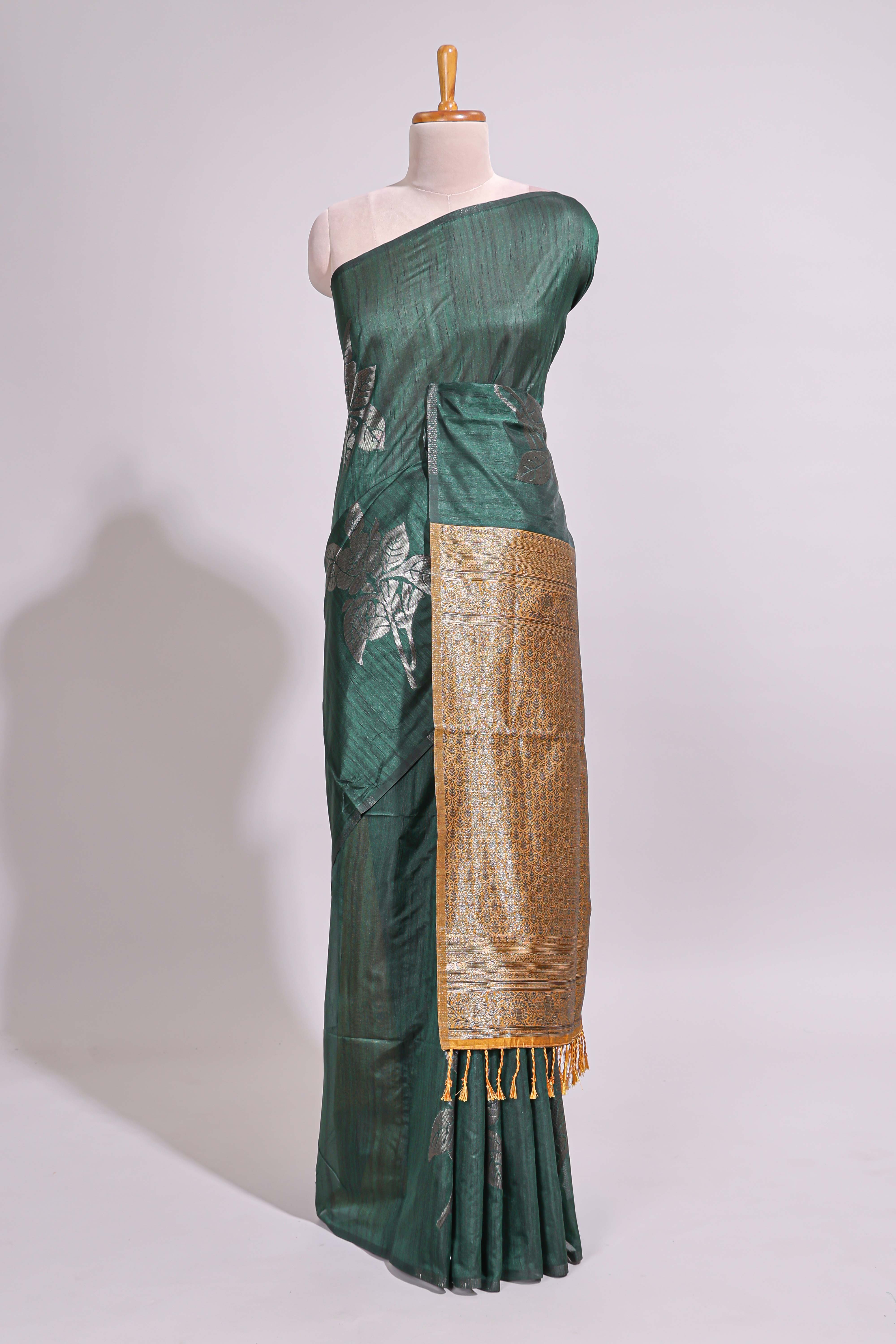 Borderless floral design green art tussar saree with contrast pallu and silver motifs blouse