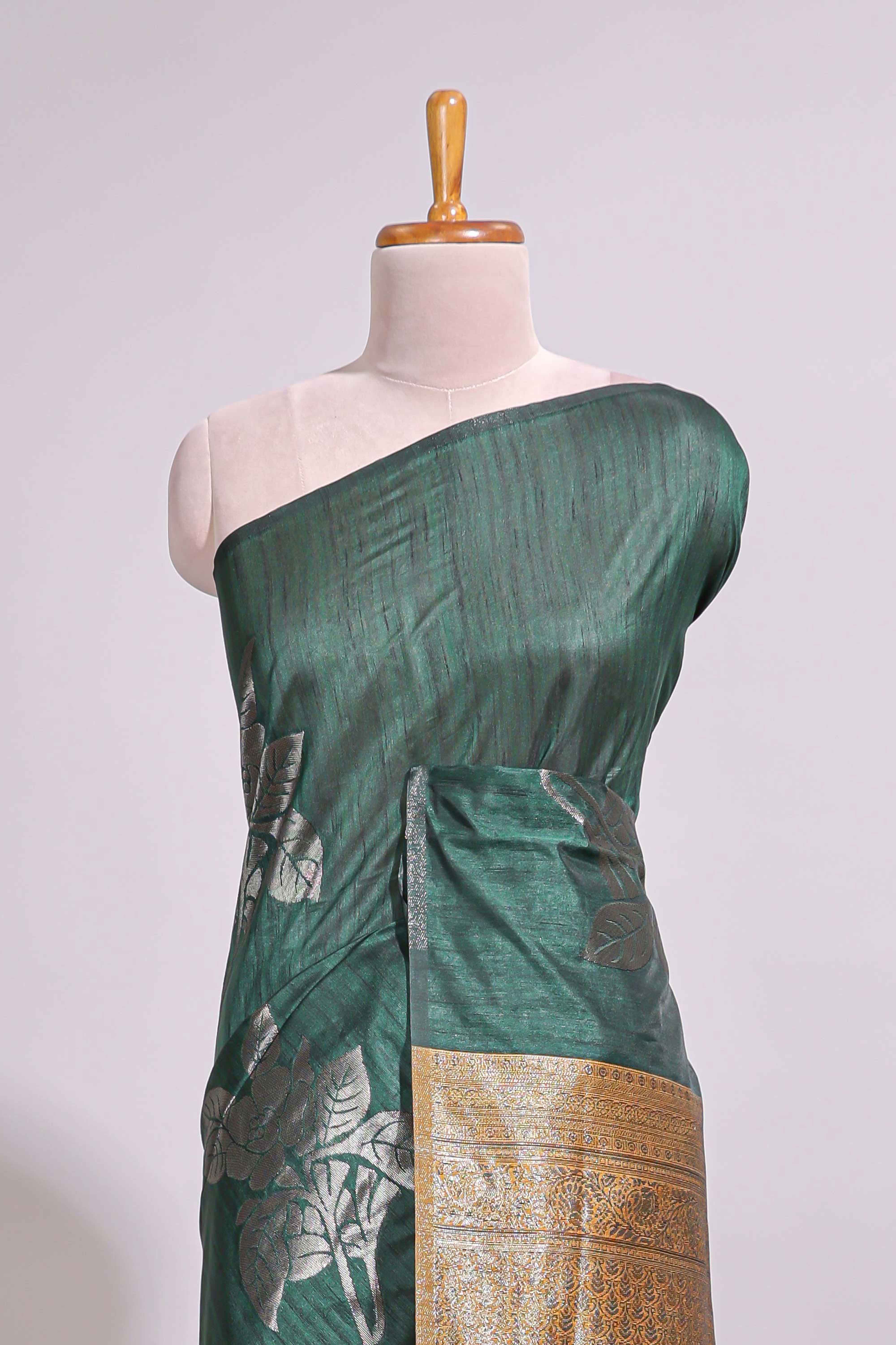 Borderless floral design green art tussar saree with contrast pallu and silver motifs blouse