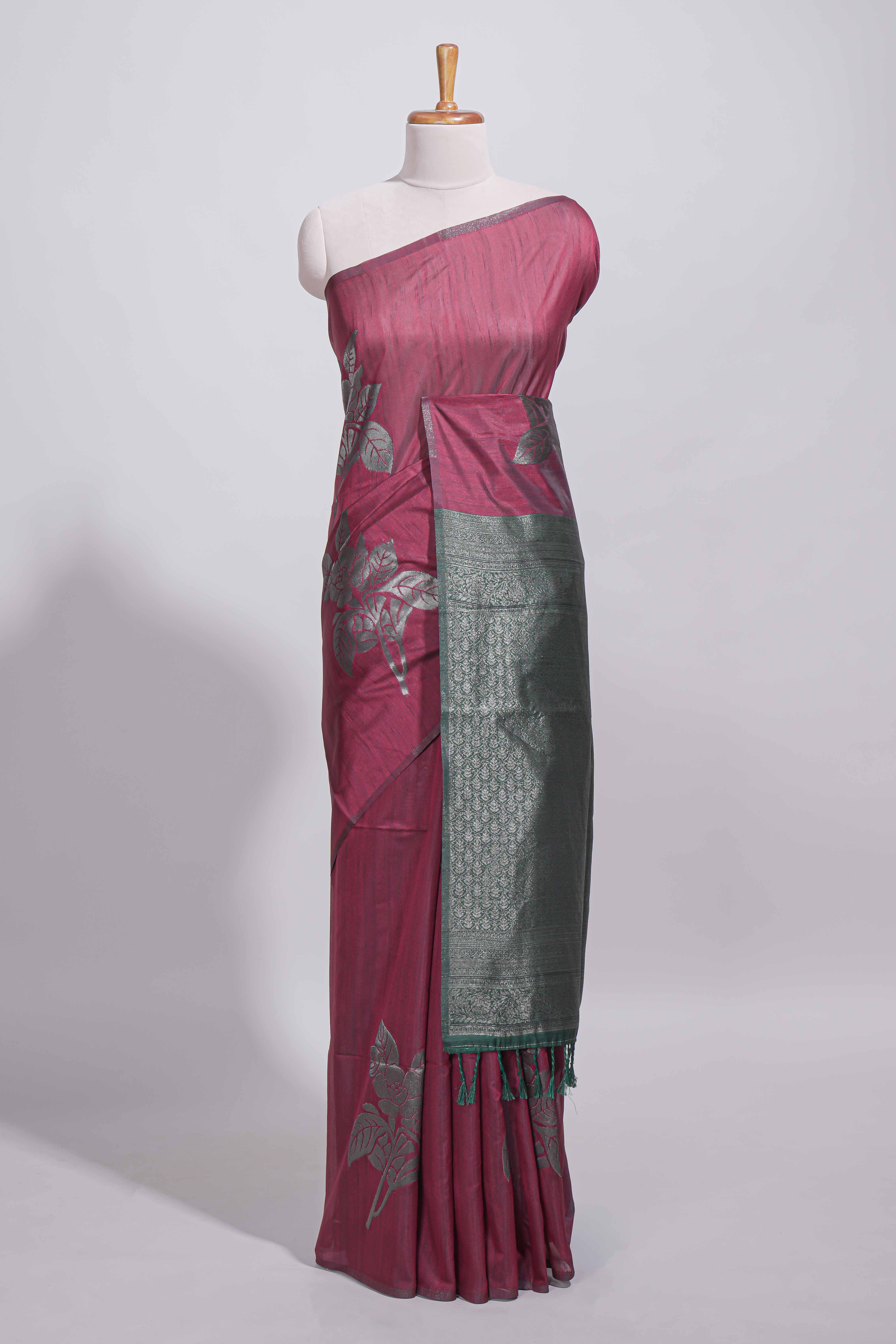 Dark maroon color tussar saree with subtle silver woven motifs paired with a rich zari pallu with tassels with contrast blouse piece