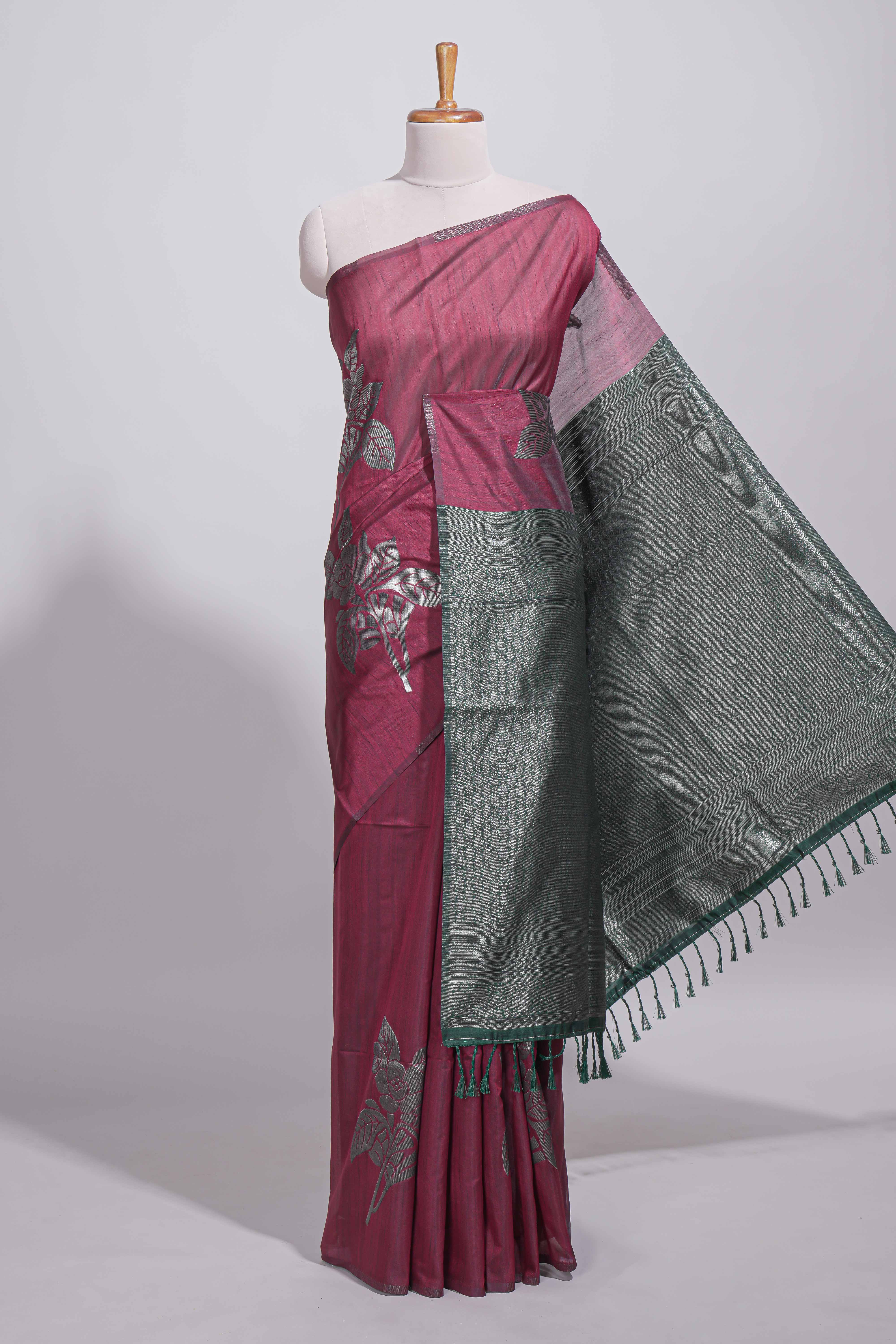 Dark maroon color tussar saree with subtle silver woven motifs paired with a rich zari pallu with tassels with contrast blouse piece