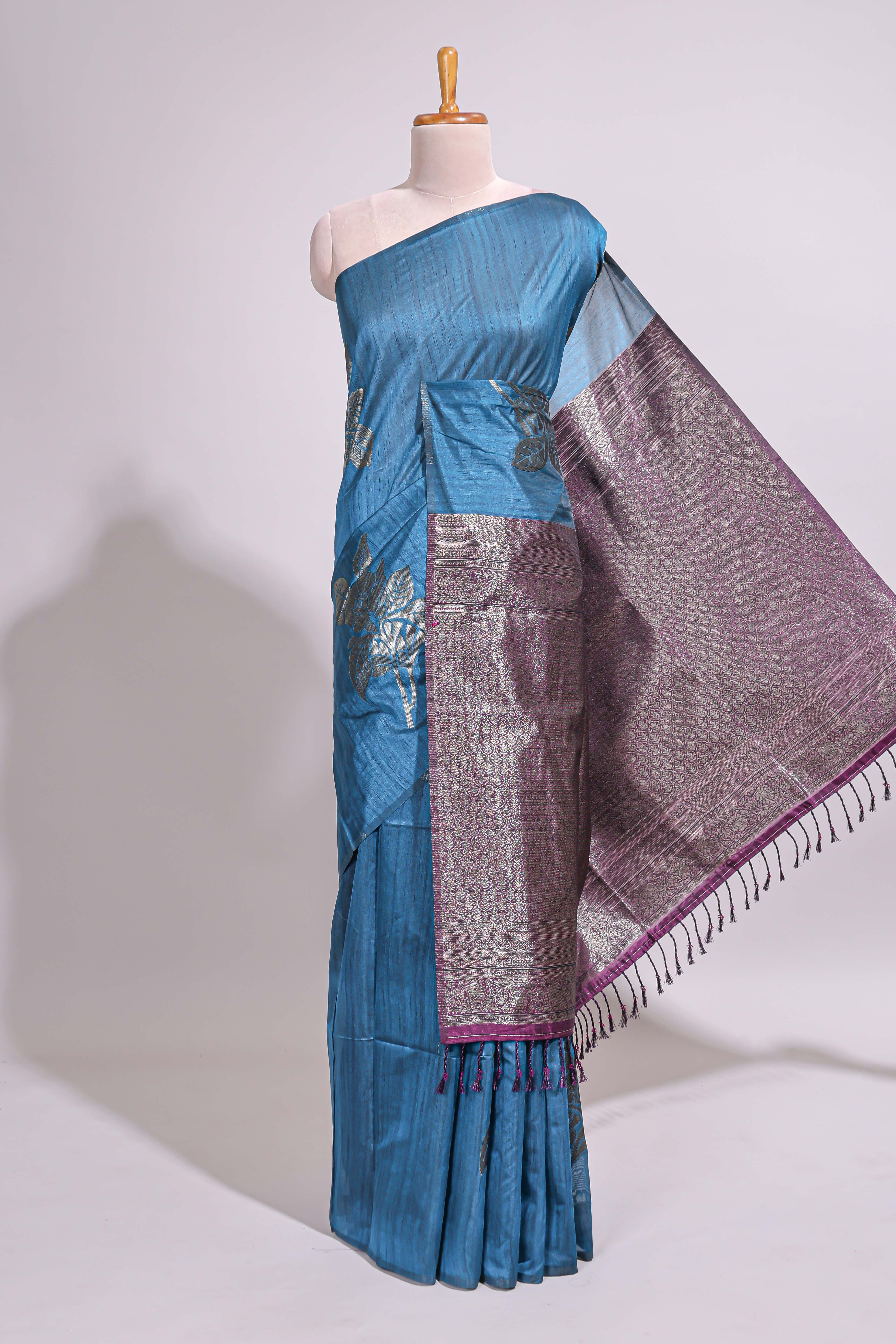 Borderless floral design blue art tussar saree with contrast pallu and silver motifs blouse