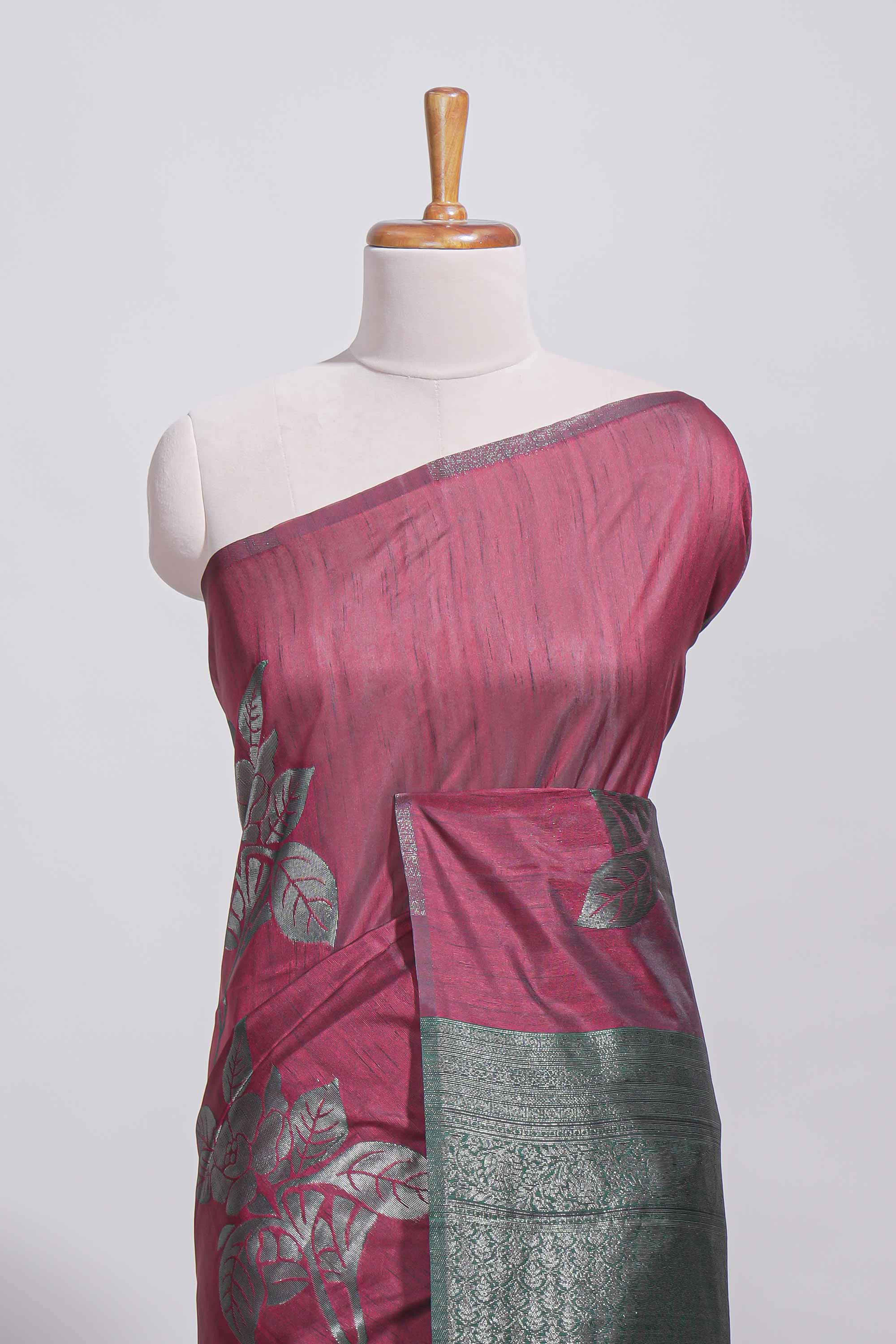 Dark maroon color tussar saree with subtle silver woven motifs paired with a rich zari pallu with tassels with contrast blouse piece