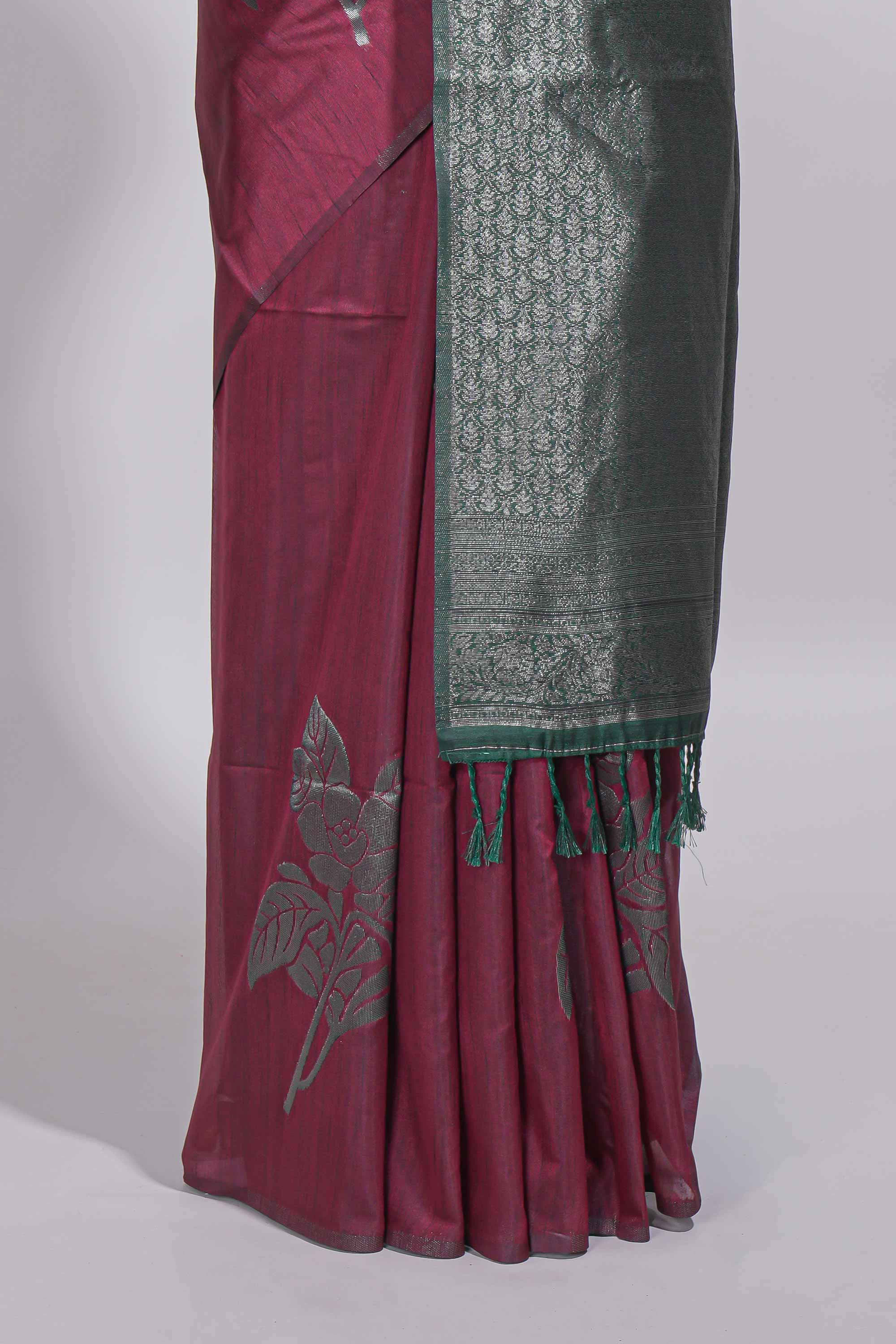 Dark maroon color tussar saree with subtle silver woven motifs paired with a rich zari pallu with tassels with contrast blouse piece