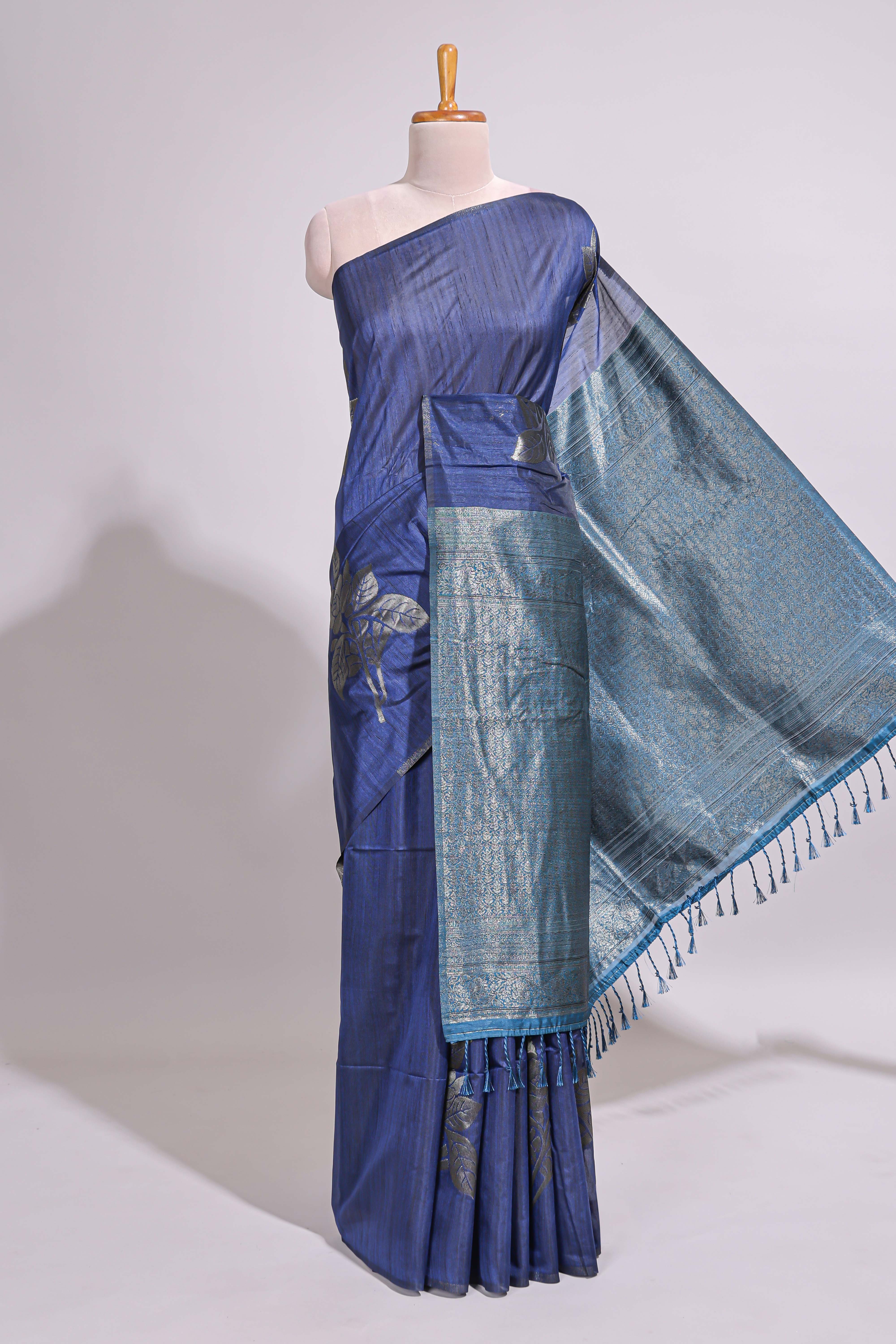 Borderless floral design blue art tussar saree with contrast pallu and silver motifs blouse