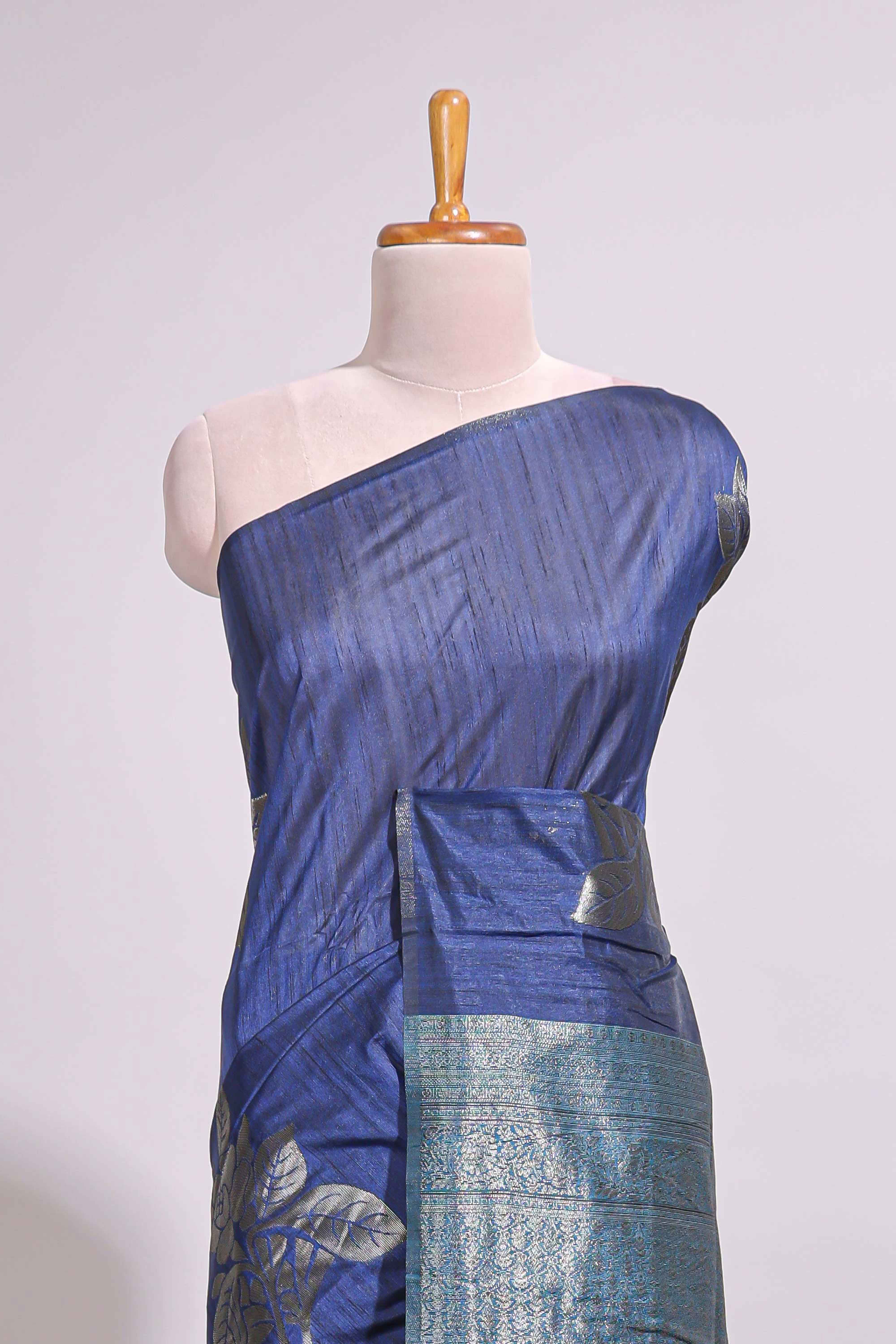 Borderless floral design blue art tussar saree with contrast pallu and silver motifs blouse