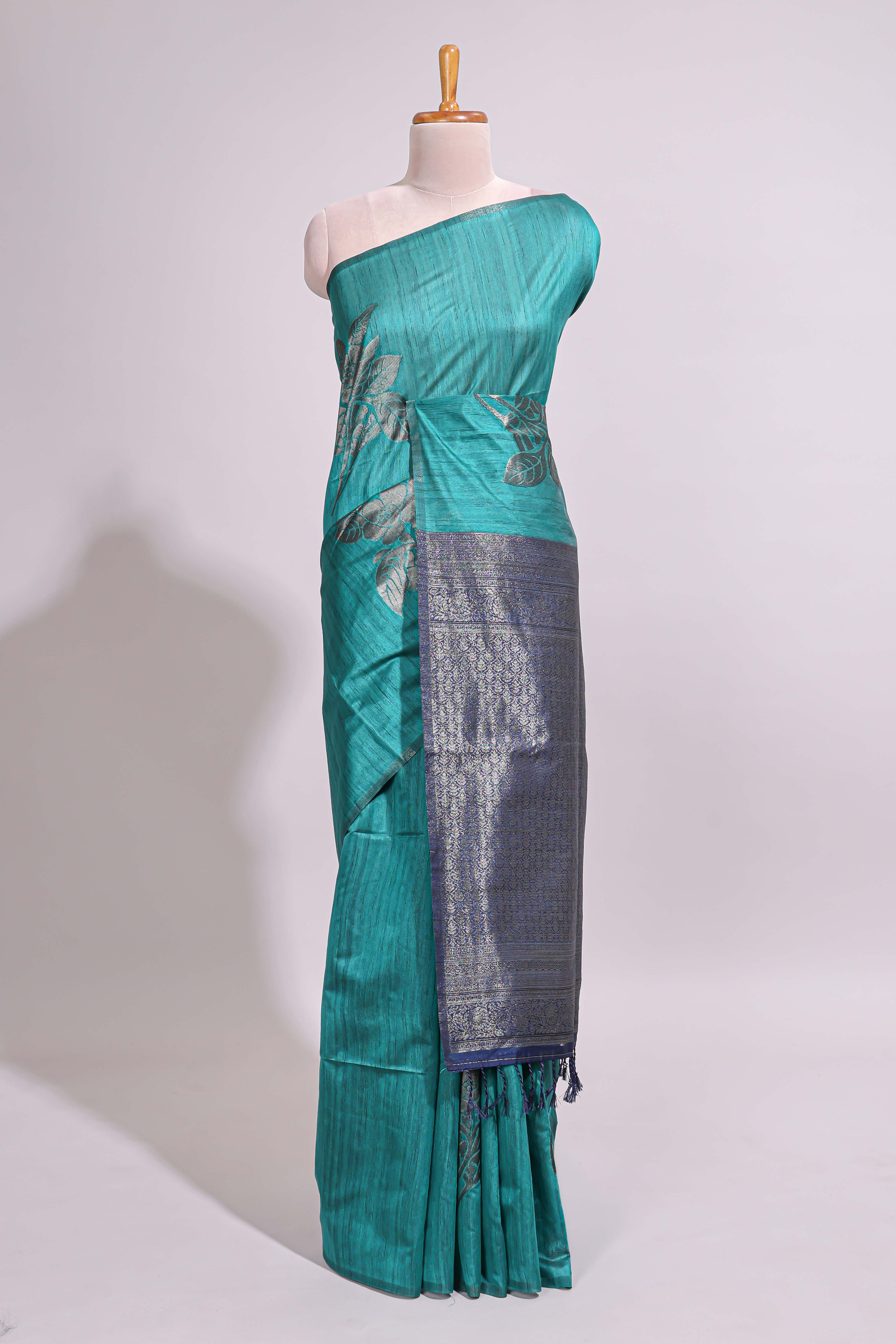 Borderless floral design green art tussar saree with contrast pallu and silver motifs blouse