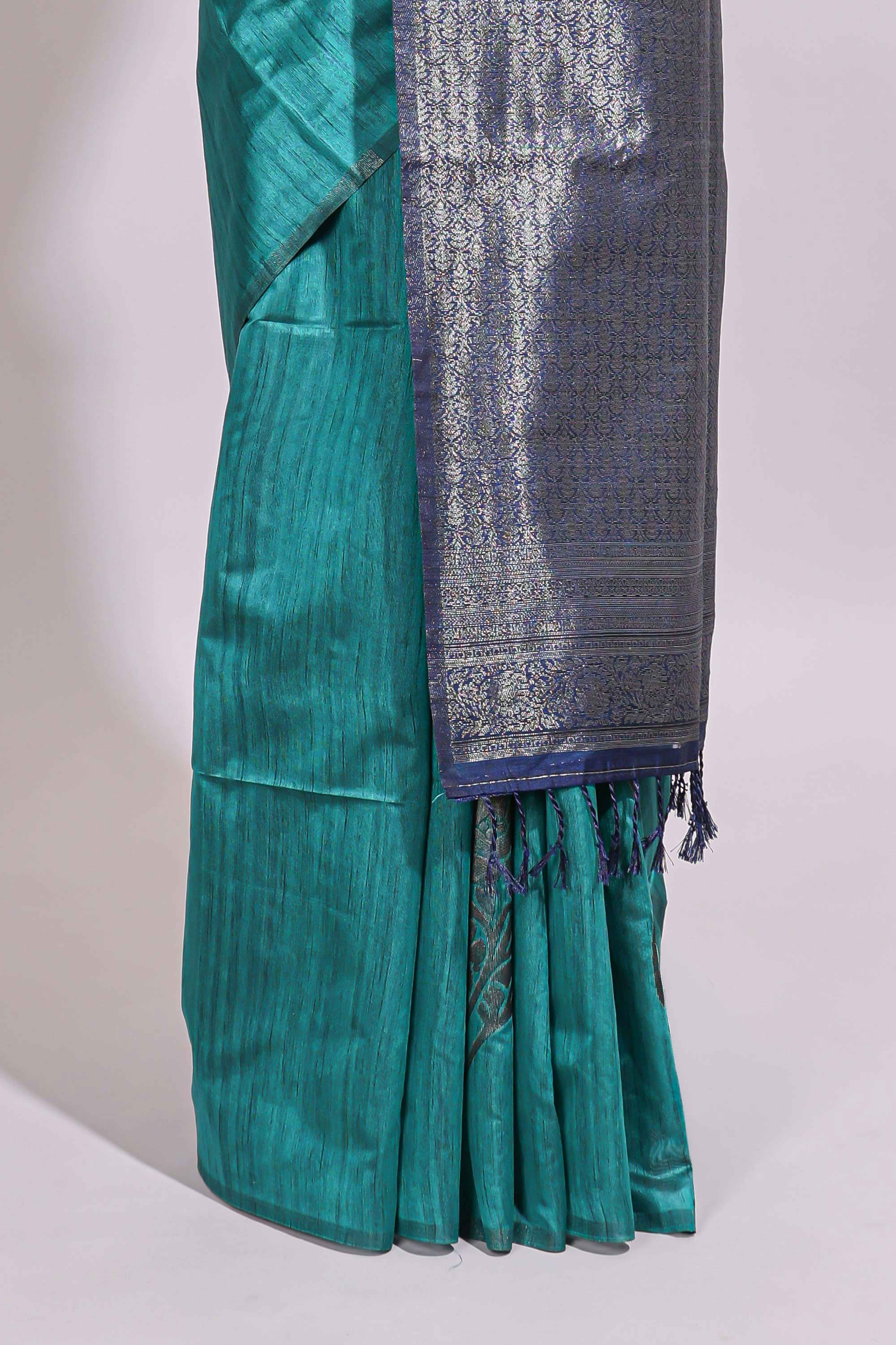 Borderless floral design green art tussar saree with contrast pallu and silver motifs blouse