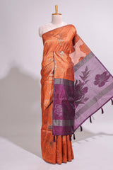 Borderless orange floral design art tusser saree with contrast pallu and floral motifs blouse