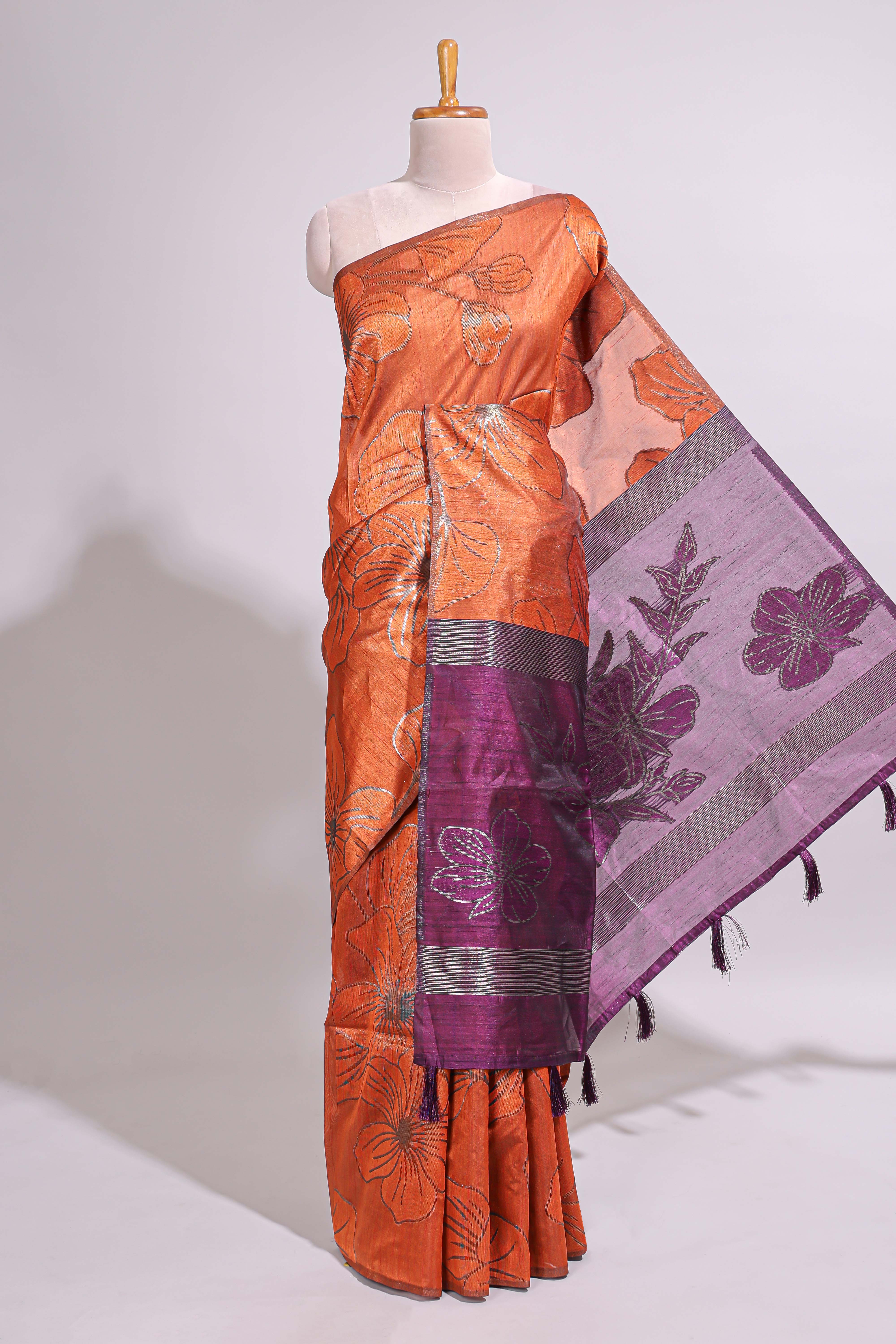 Borderless orange floral design art tusser saree with contrast pallu and floral motifs blouse