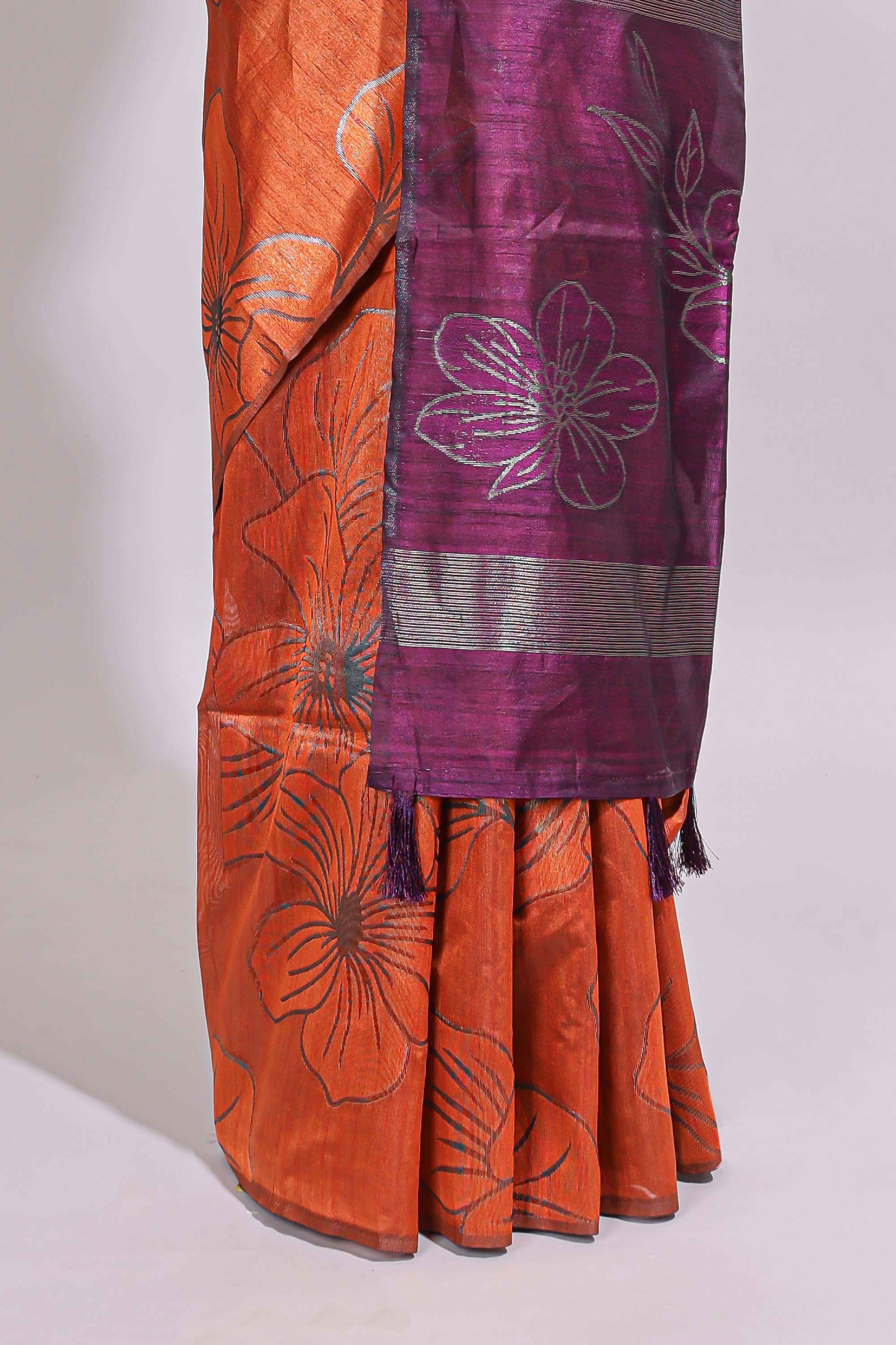 Borderless orange floral design art tusser saree with contrast pallu and floral motifs blouse