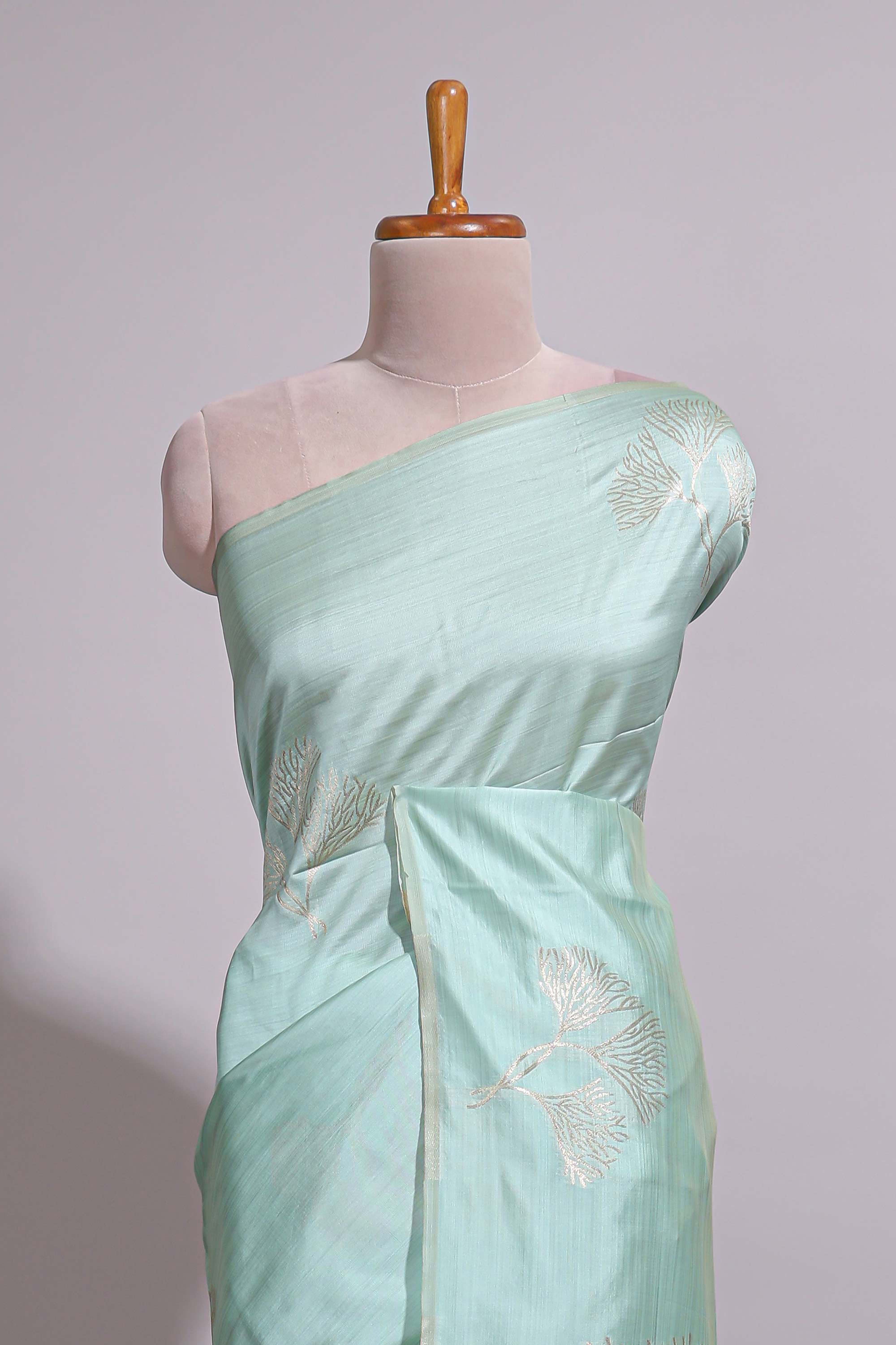 Green zari floral design art tusser saree with self zari border and matching floral motits blouse