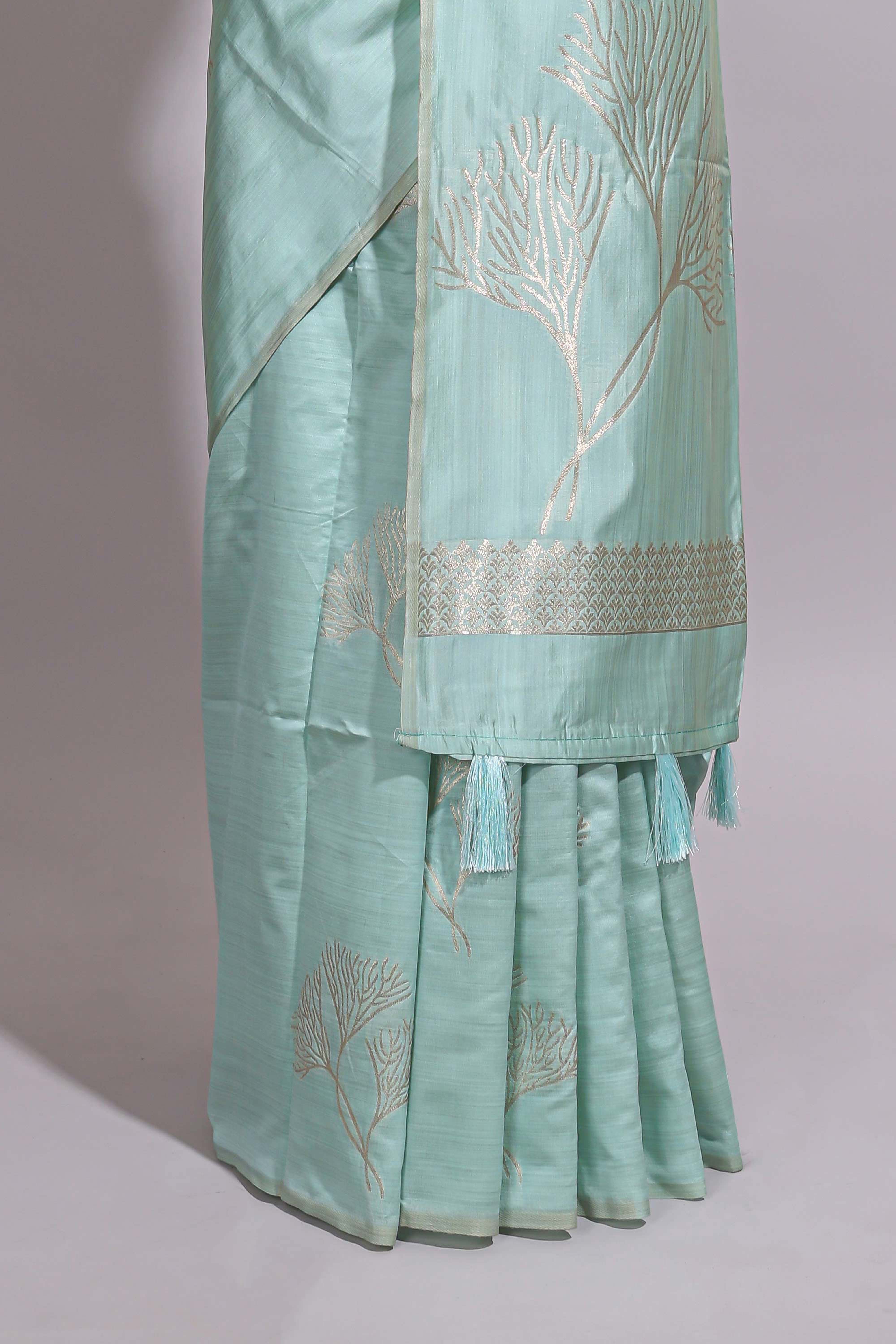 Green zari floral design art tusser saree with self zari border and matching floral motits blouse