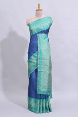 Blue geometric zari butta art tussar saree with contrast zari border and striped blouse