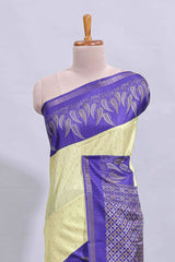 Pale yellow geometric zari butta art tussar saree with contrast zari border and striped blouse