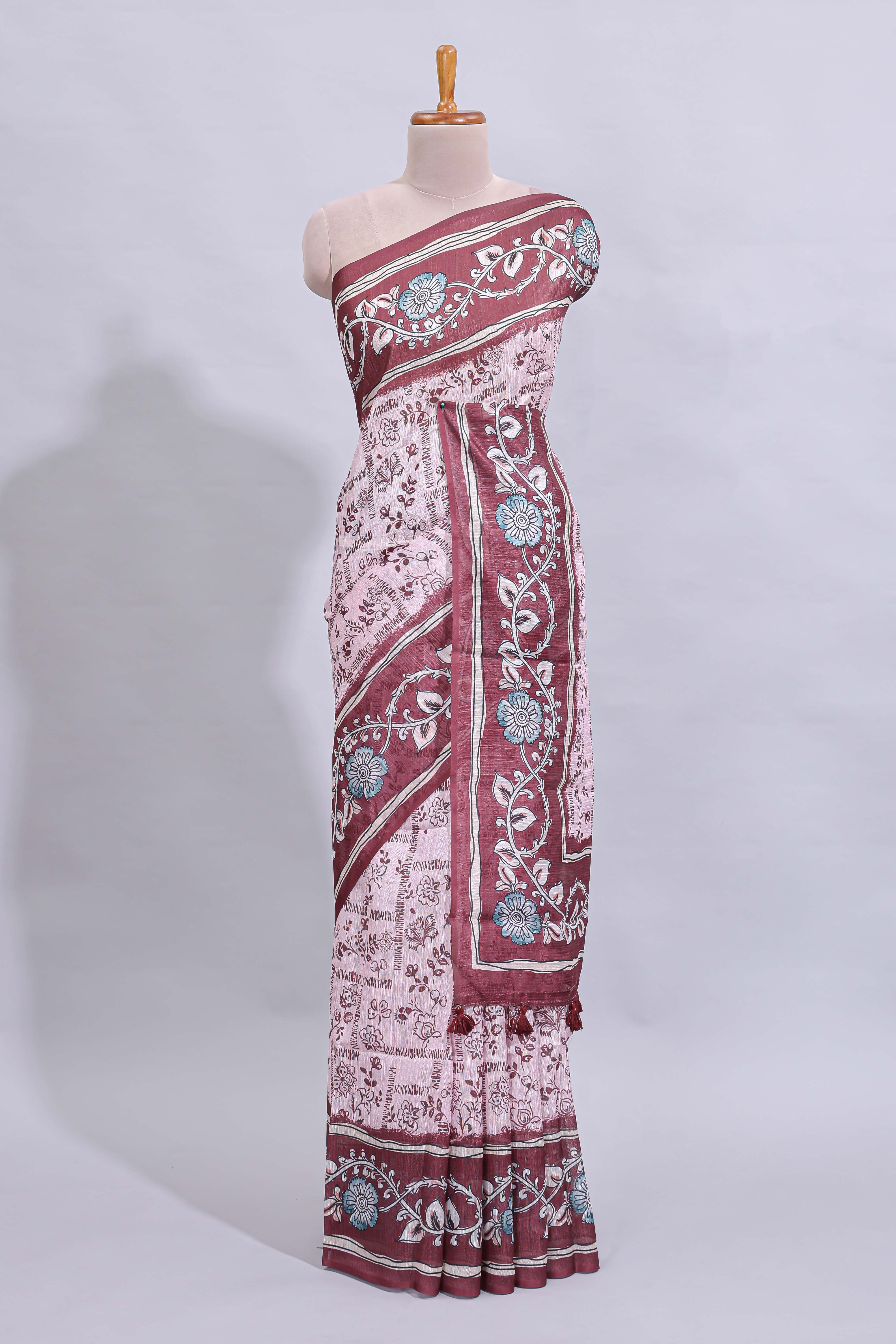 Pale pink floral design art tussar saree with contrast border and matching motifs blouse