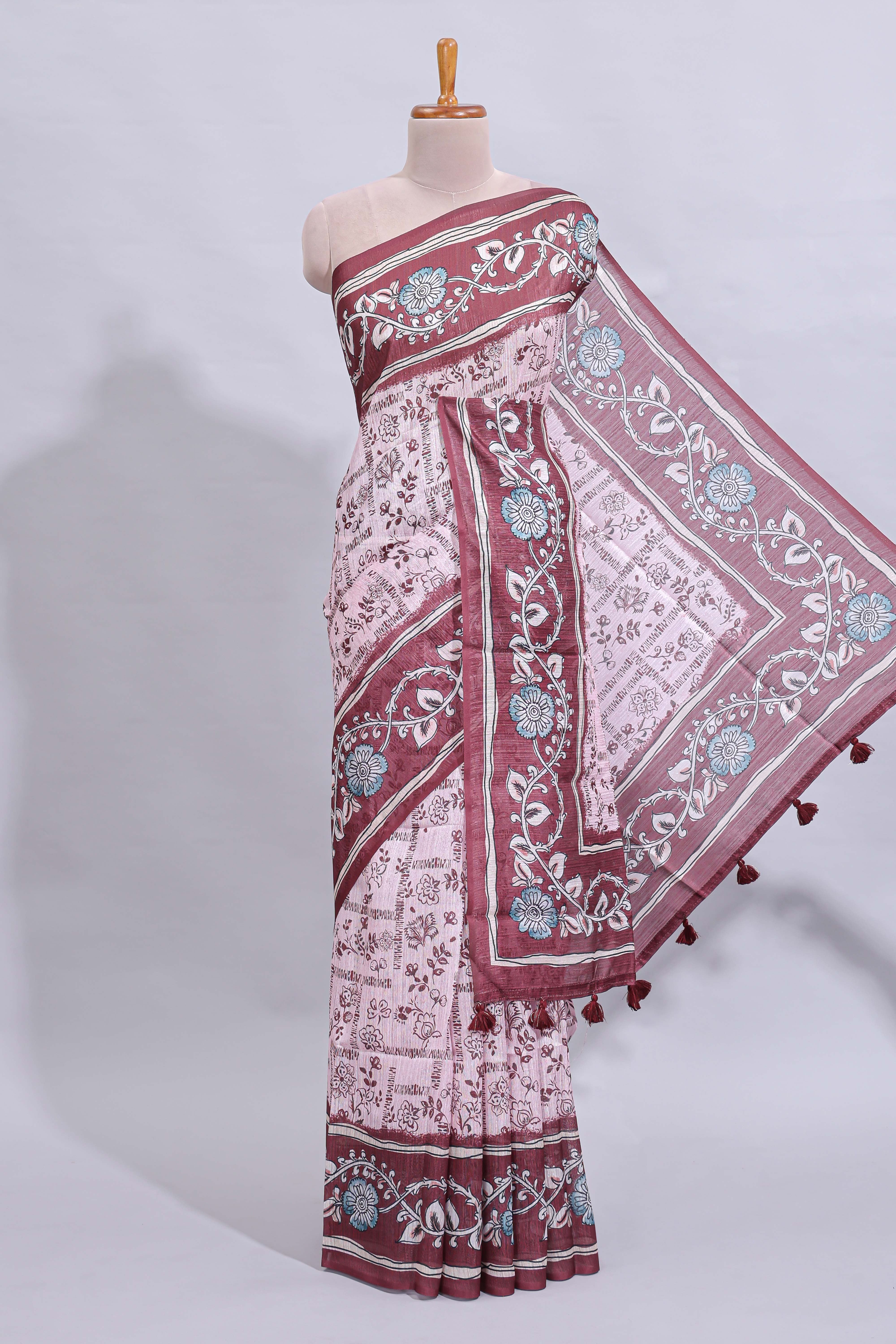 Pale pink floral design art tussar saree with contrast border and matching motifs blouse