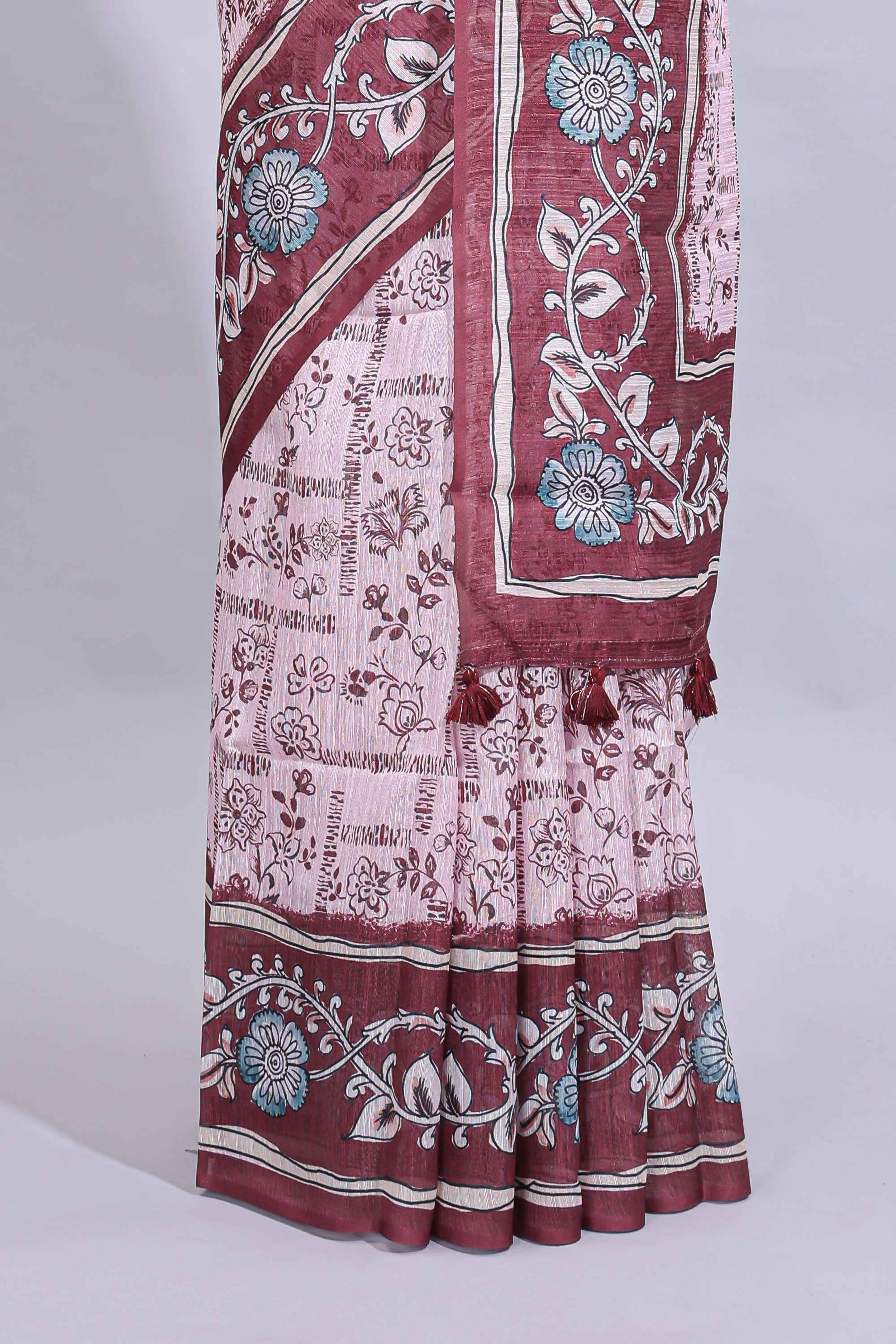 Pale pink floral design art tussar saree with contrast border and matching motifs blouse