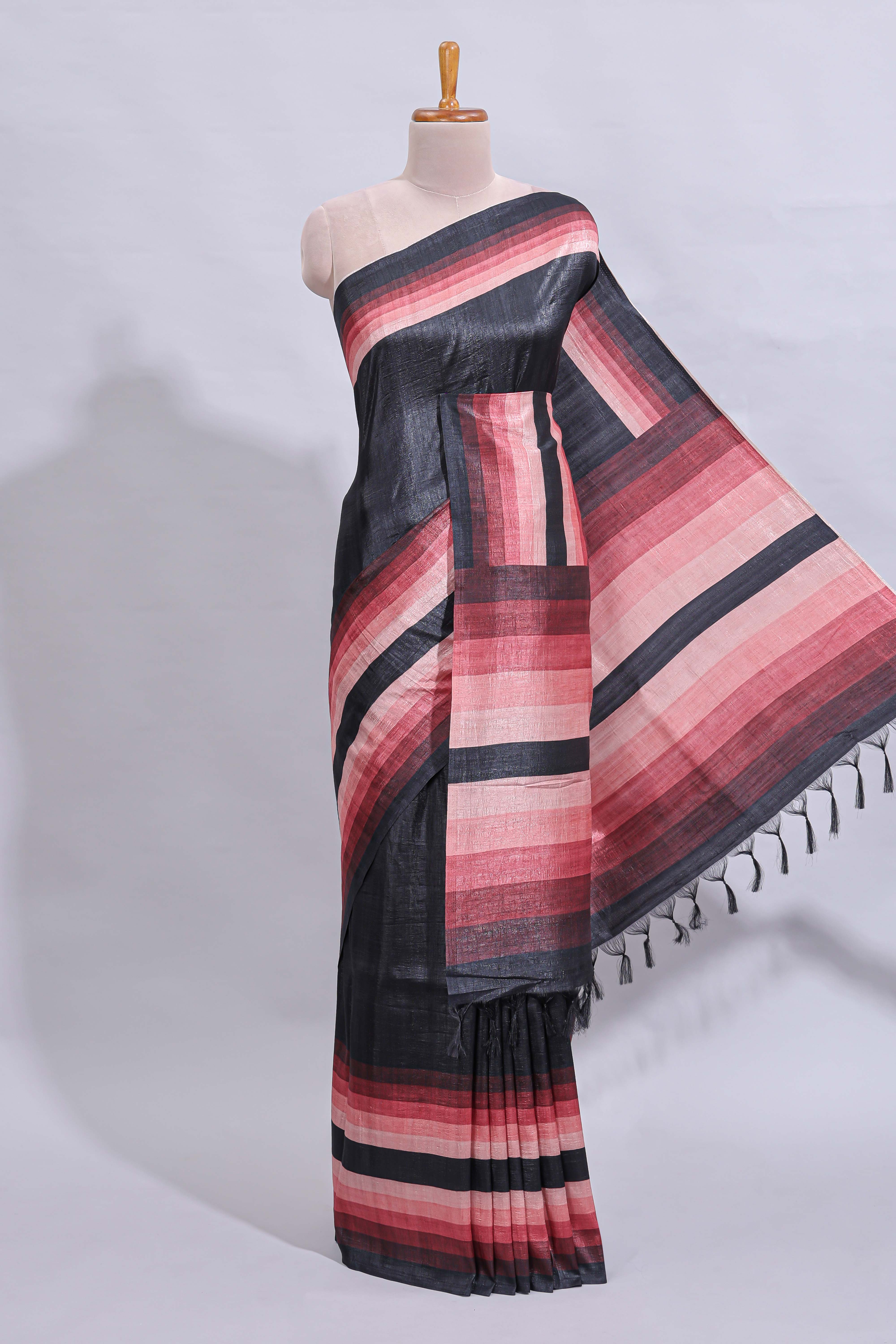 Black textured plain art tussar saree with contrast pink border and matching striped blouse
