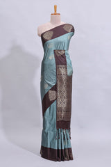 Powder blue floral motifs art tussar saree with contrast zari border and plain blouse
