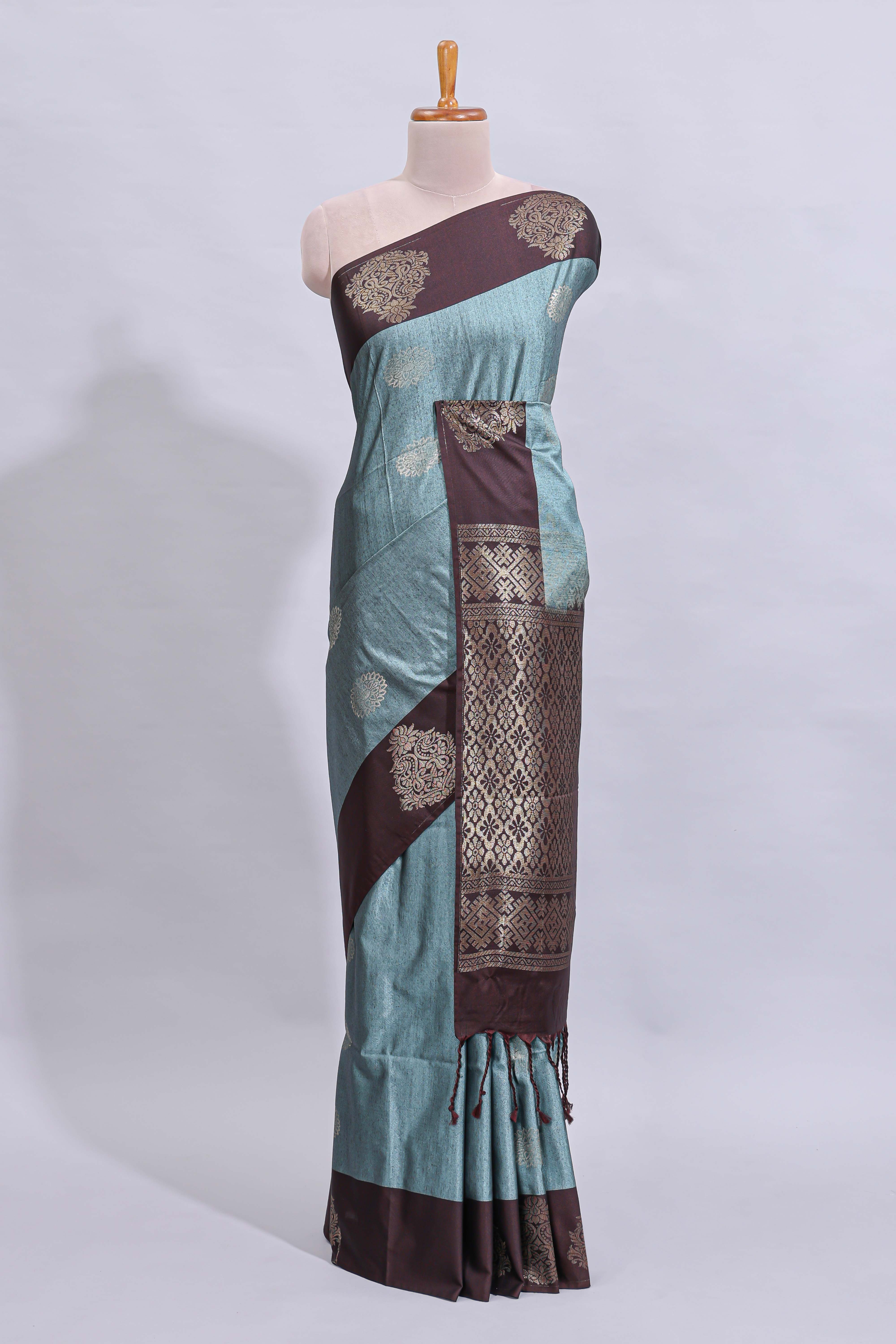 Powder blue floral motifs art tussar saree with contrast zari border and plain blouse