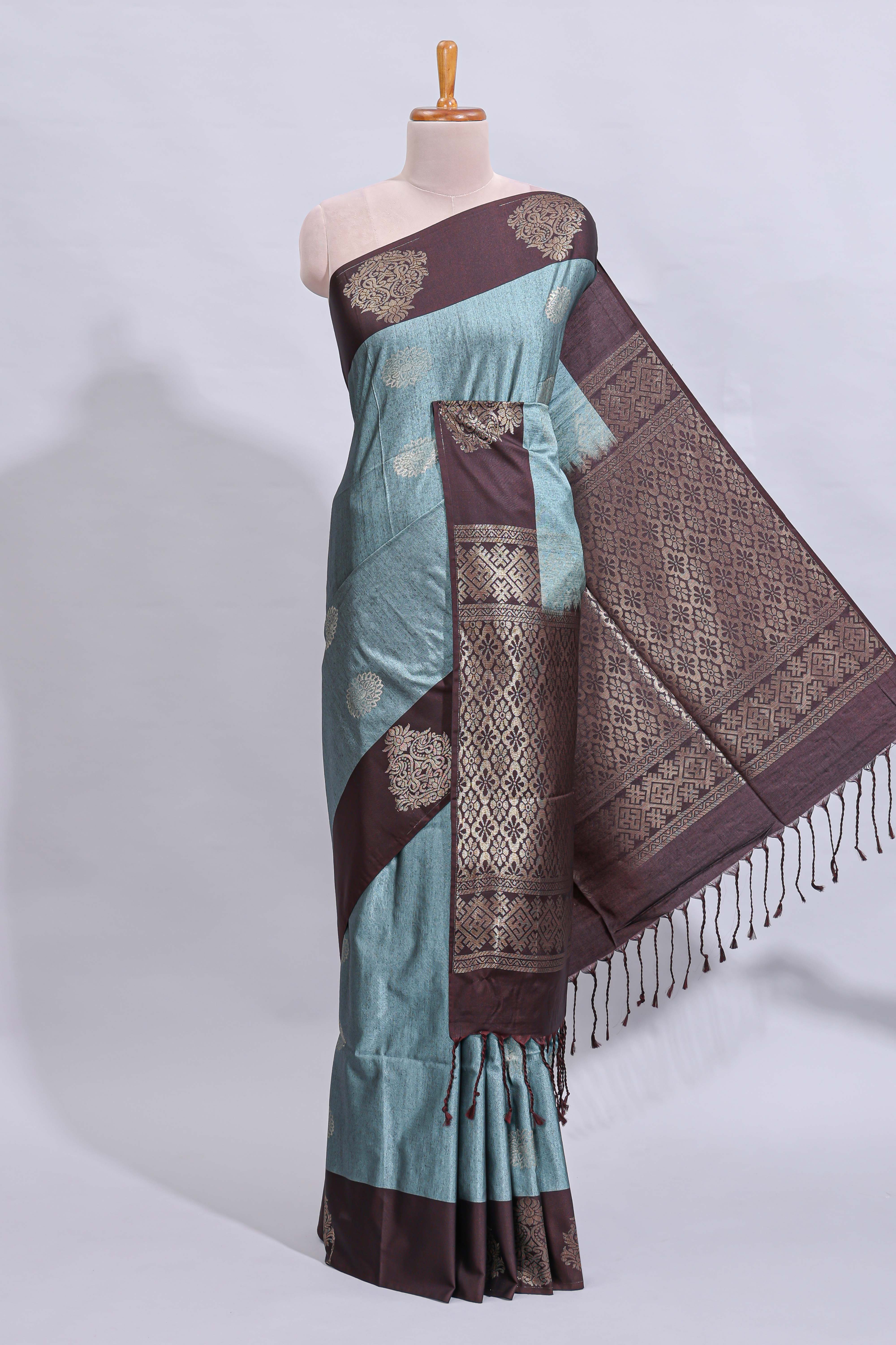 Powder blue floral motifs art tussar saree with contrast zari border and plain blouse