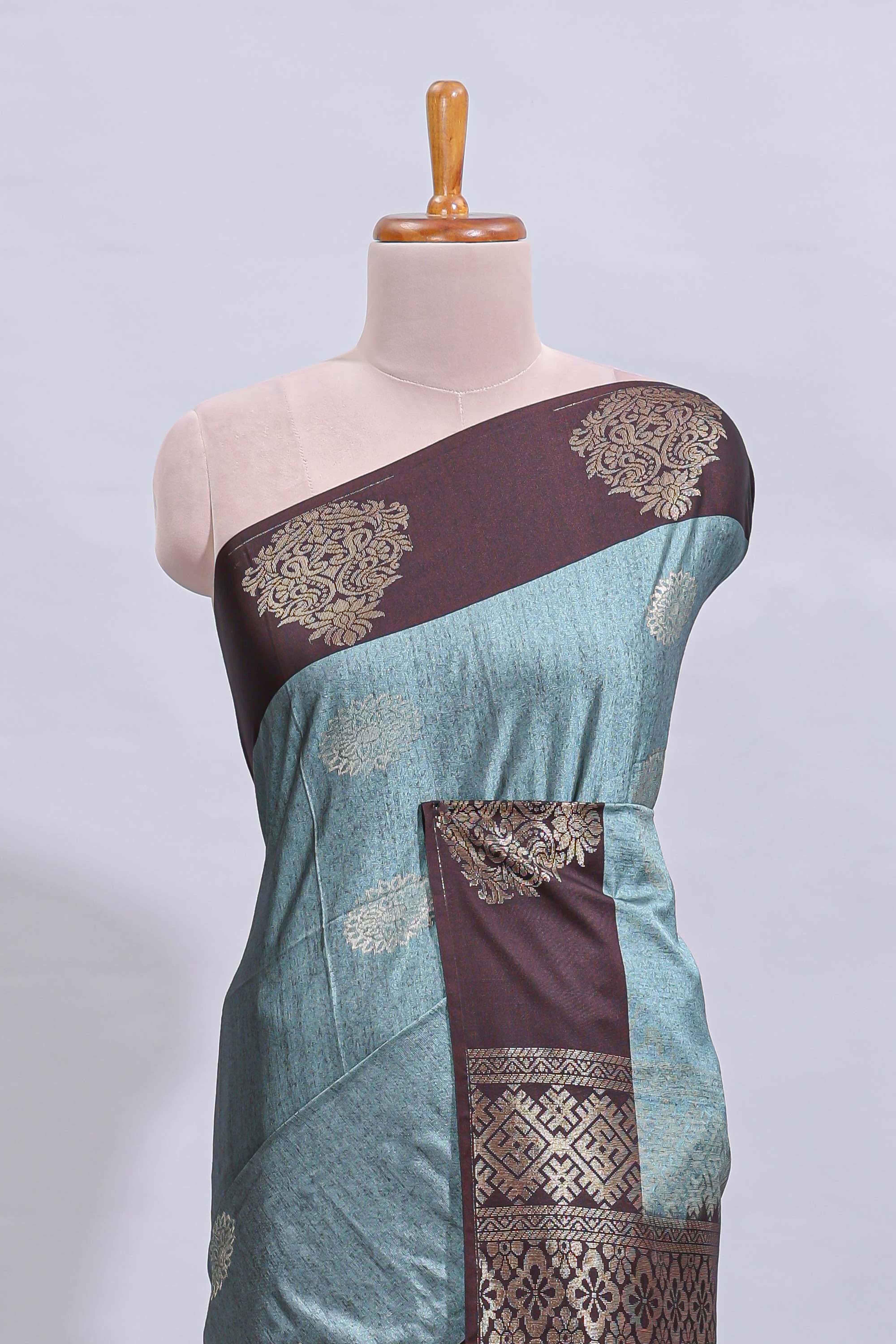 Powder blue floral motifs art tussar saree with contrast zari border and plain blouse