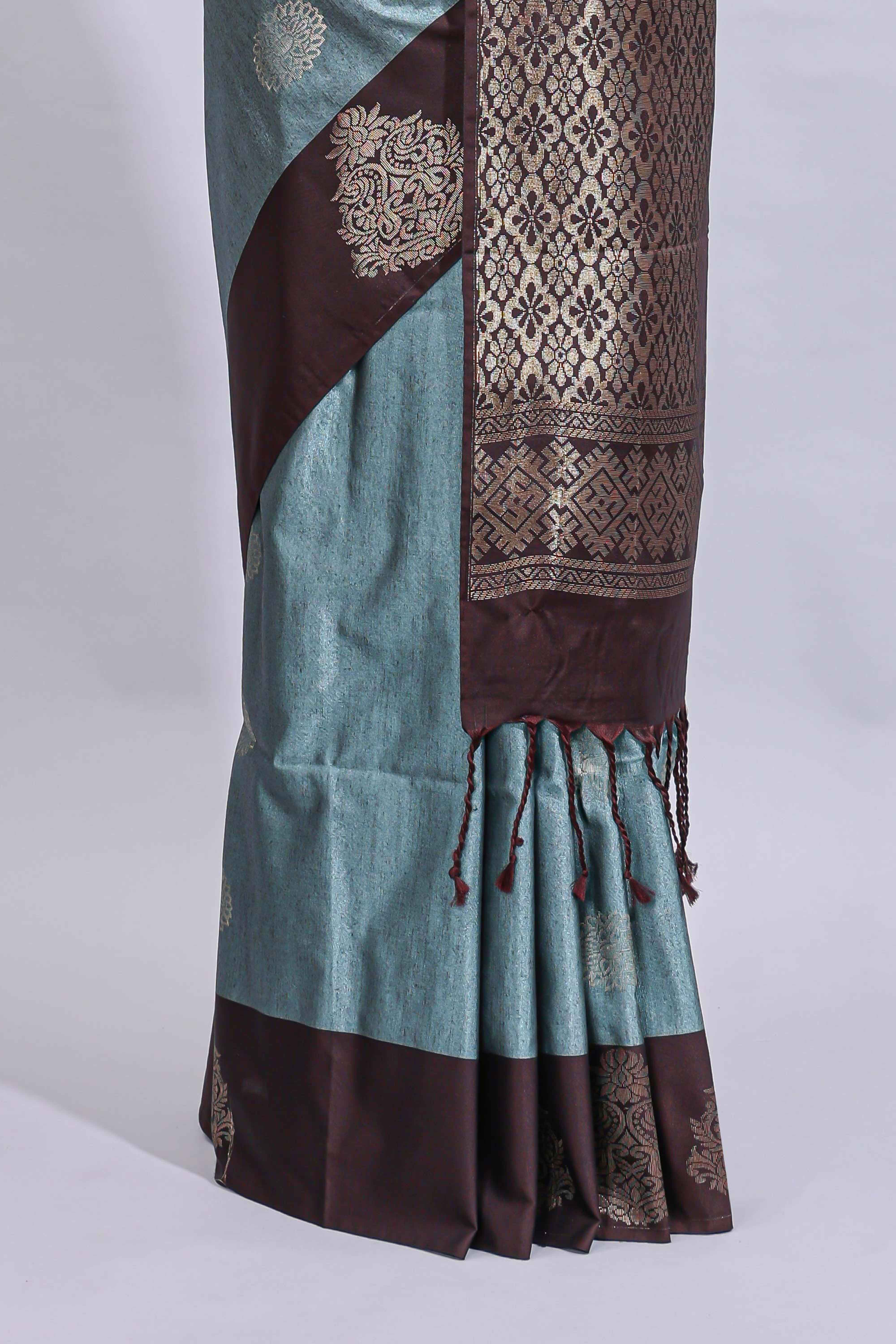 Powder blue floral motifs art tussar saree with contrast zari border and plain blouse