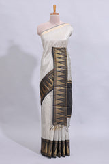 Light grey checked art tussar saree with contrast temple zari border and striped blouse