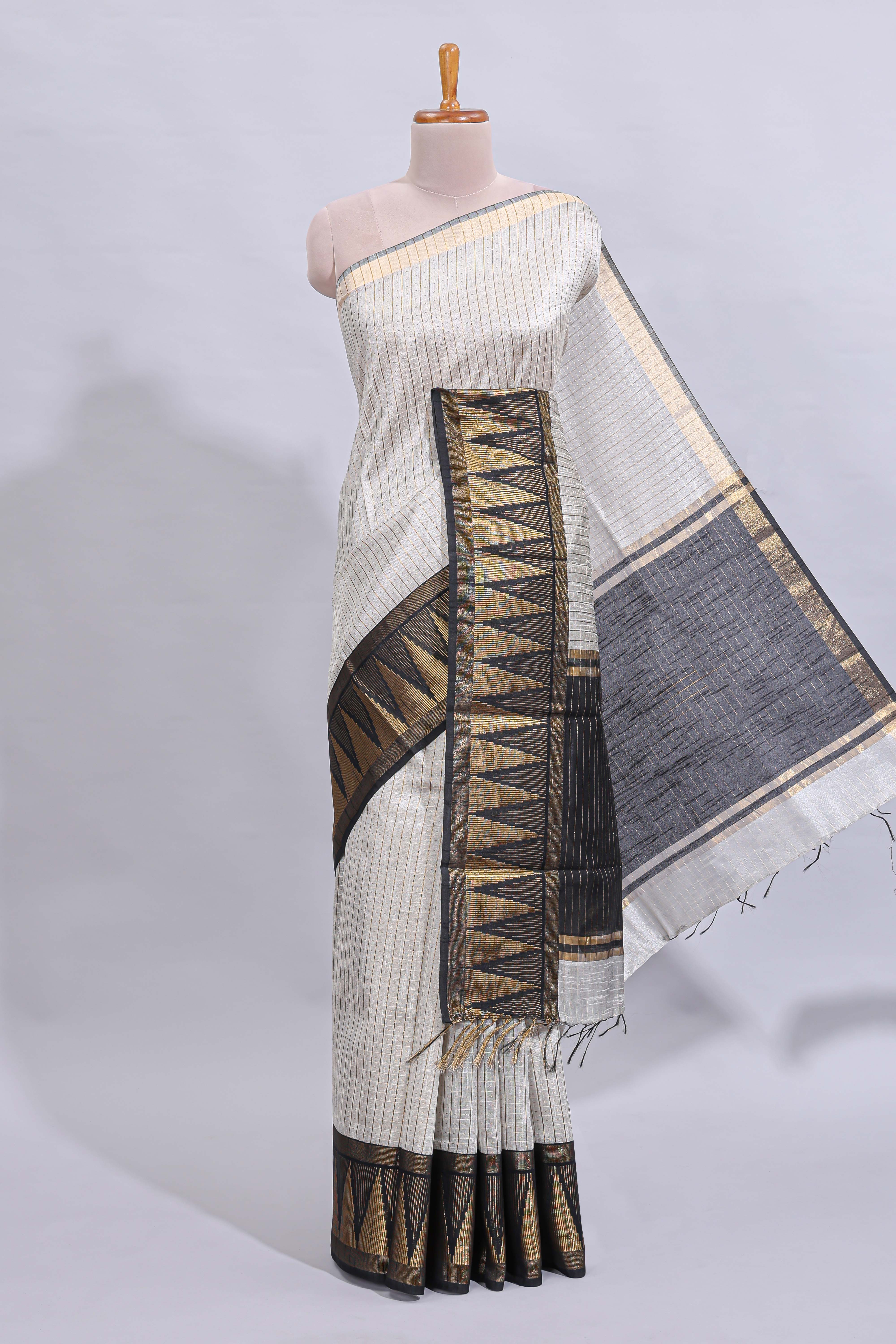 Light grey checked art tussar saree with contrast temple zari border and striped blouse