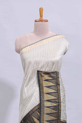 Light grey checked art tussar saree with contrast temple zari border and striped blouse