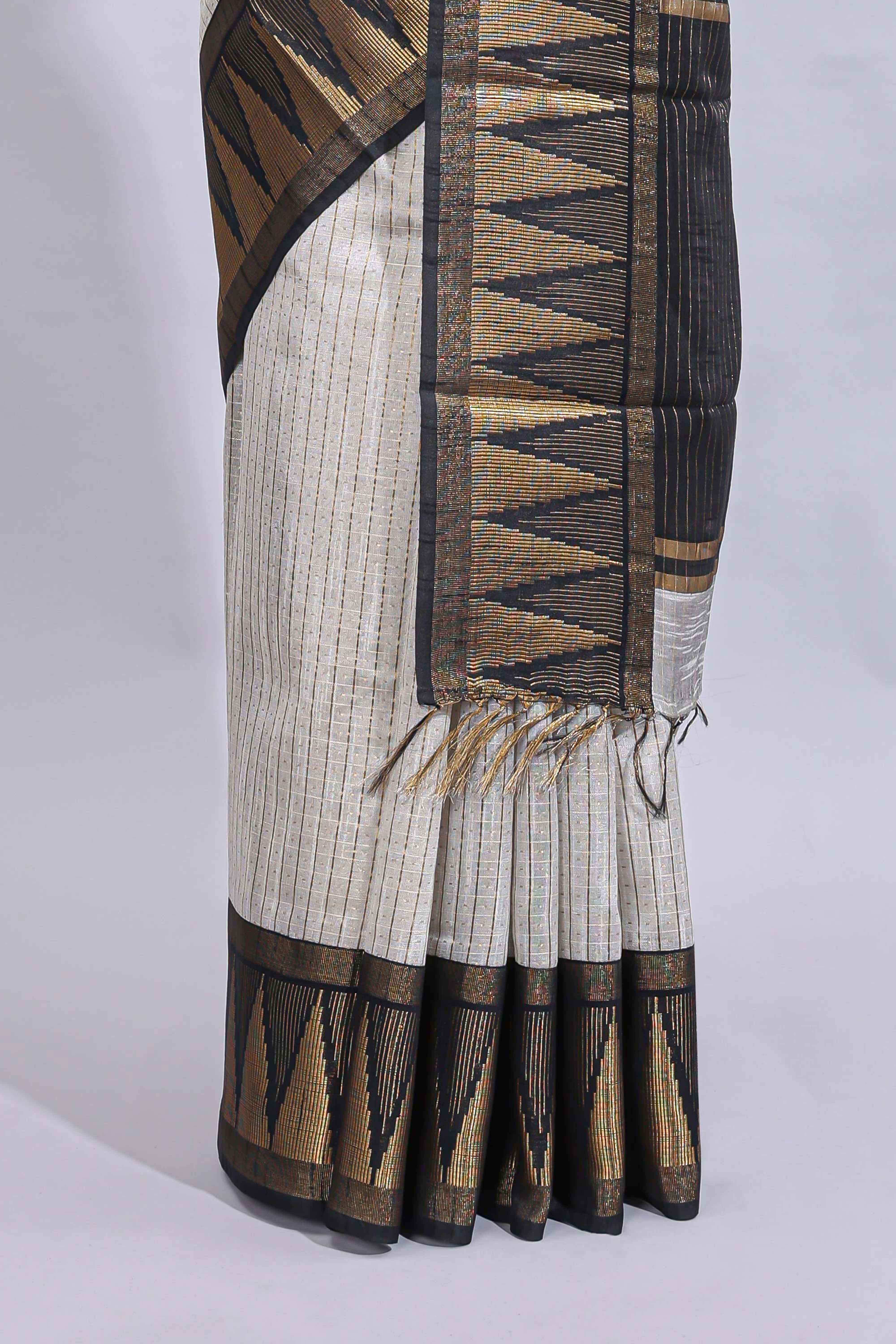 Light grey checked art tussar saree with contrast temple zari border and striped blouse