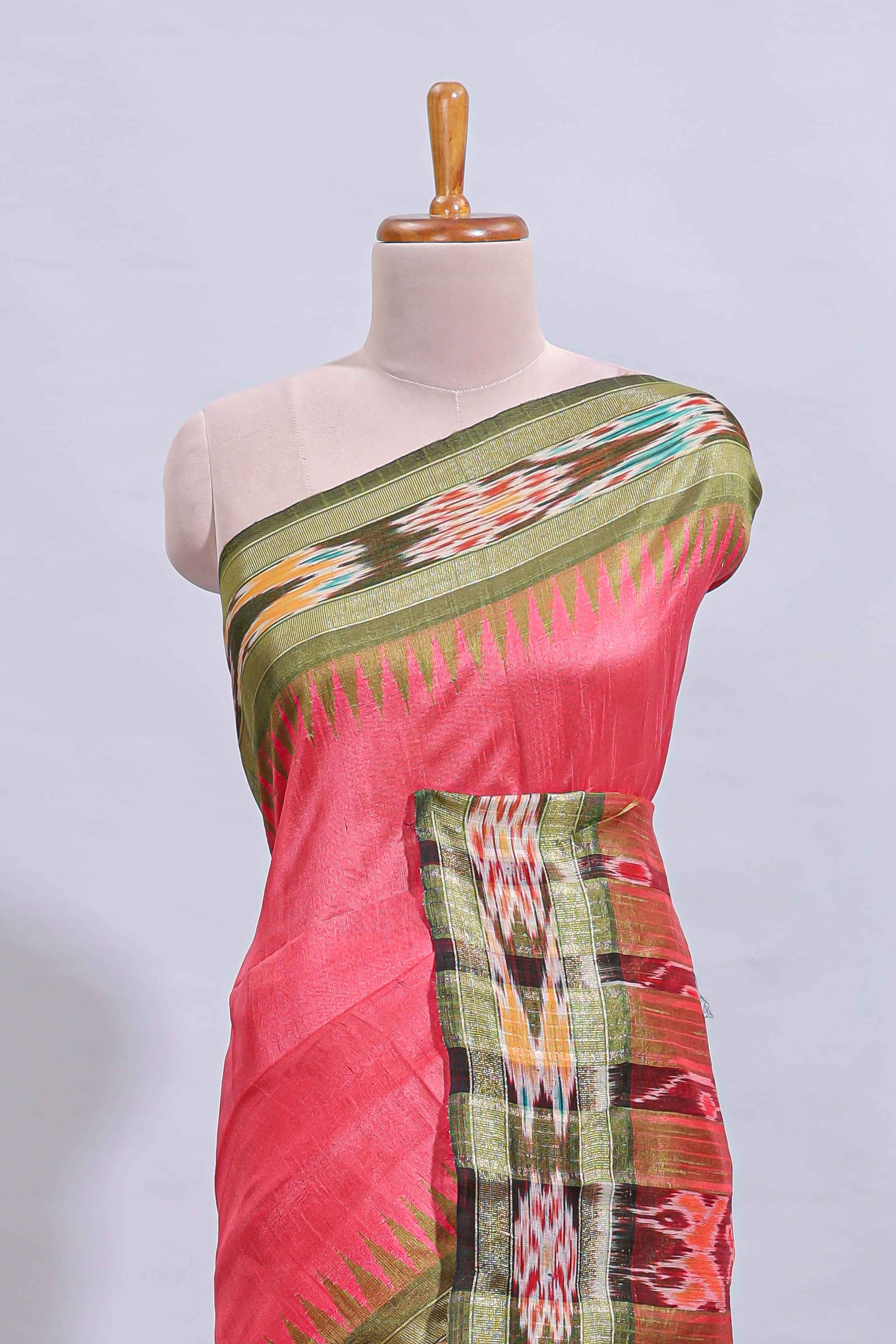 Pink plain art tussar saree with contrast ikkat style border and floral design striped pallu