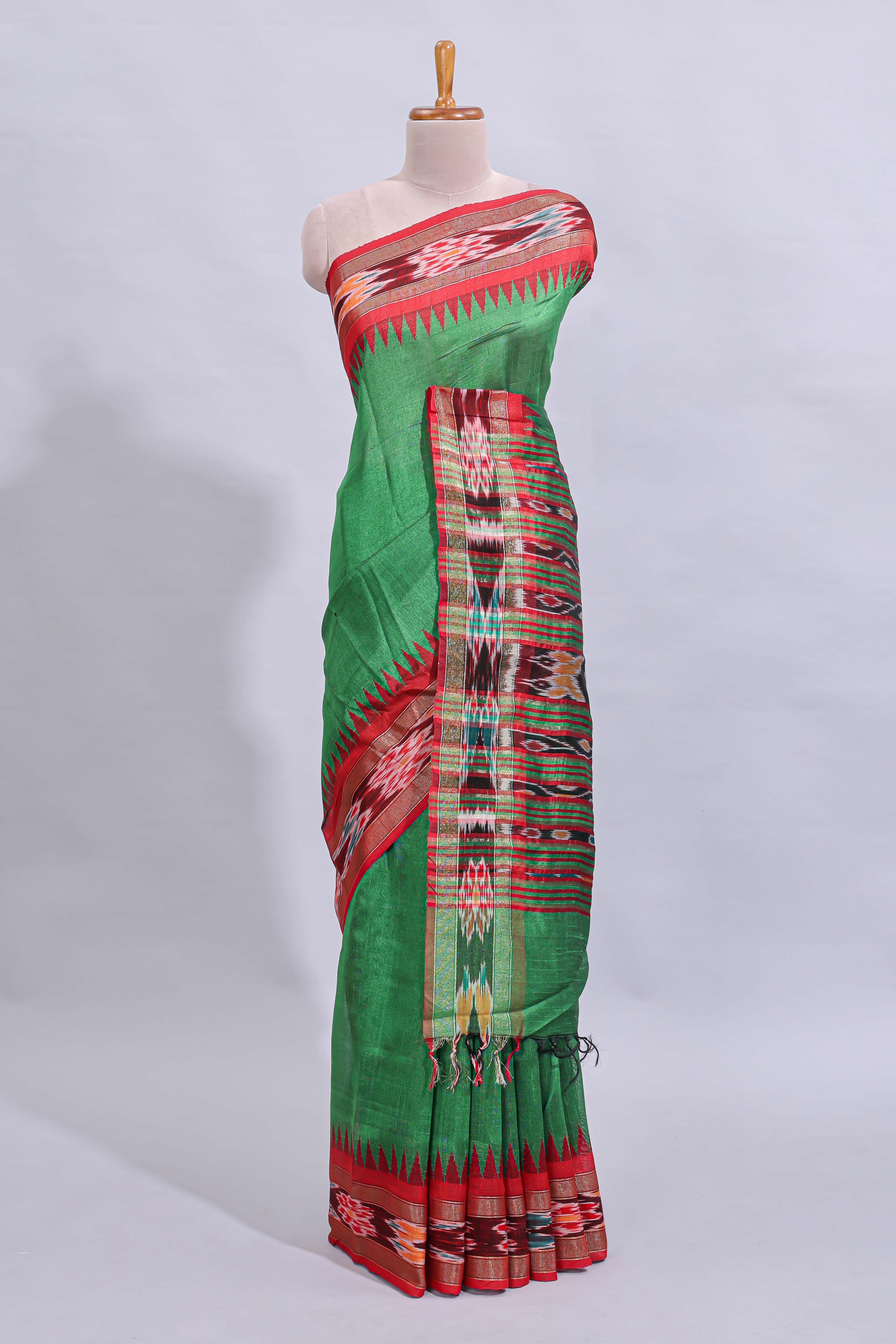 Green plain art tussar saree with contrast ikkat style border and floral design striped pallu