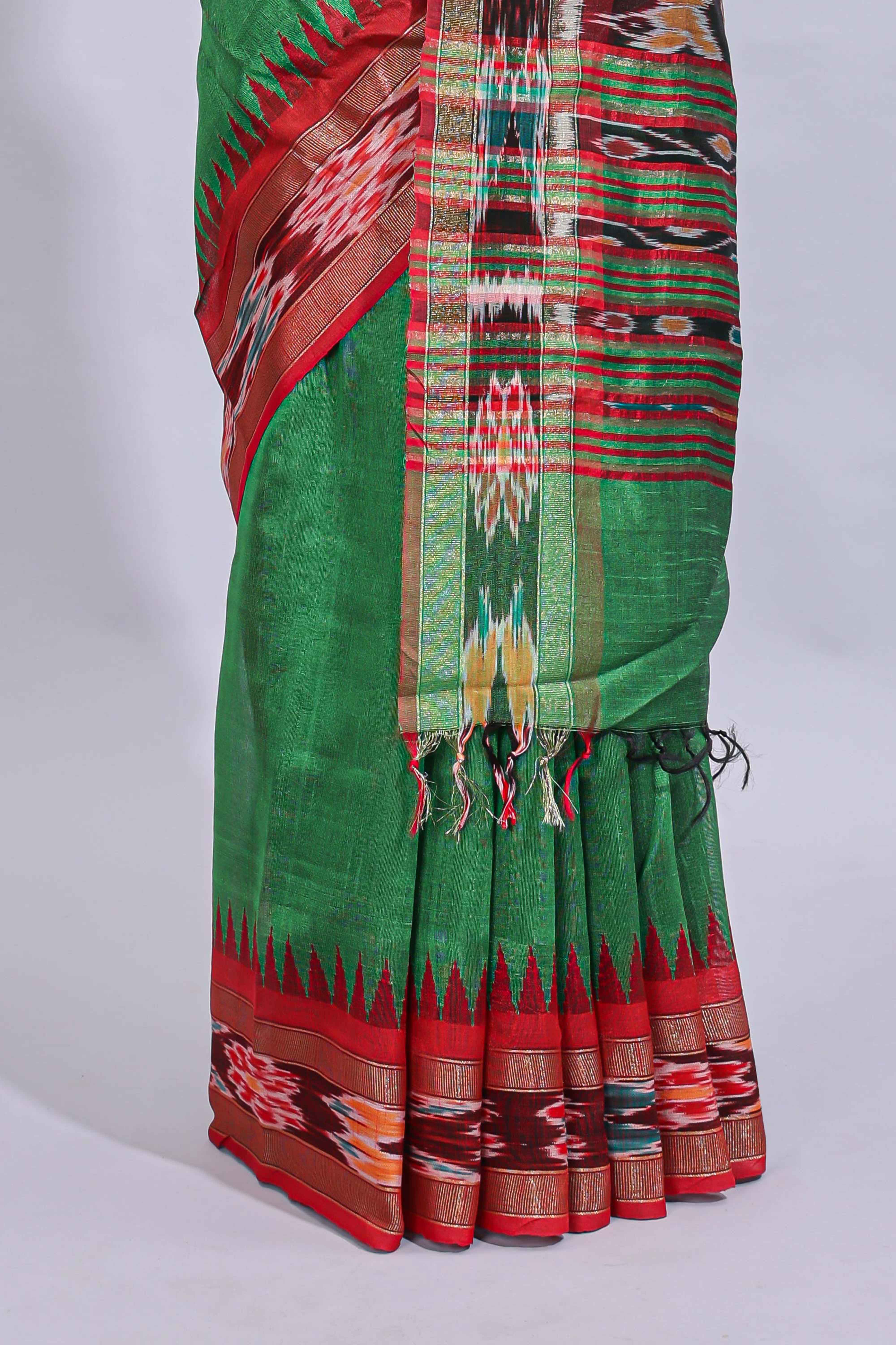 Green plain art tussar saree with contrast ikkat style border and floral design striped pallu