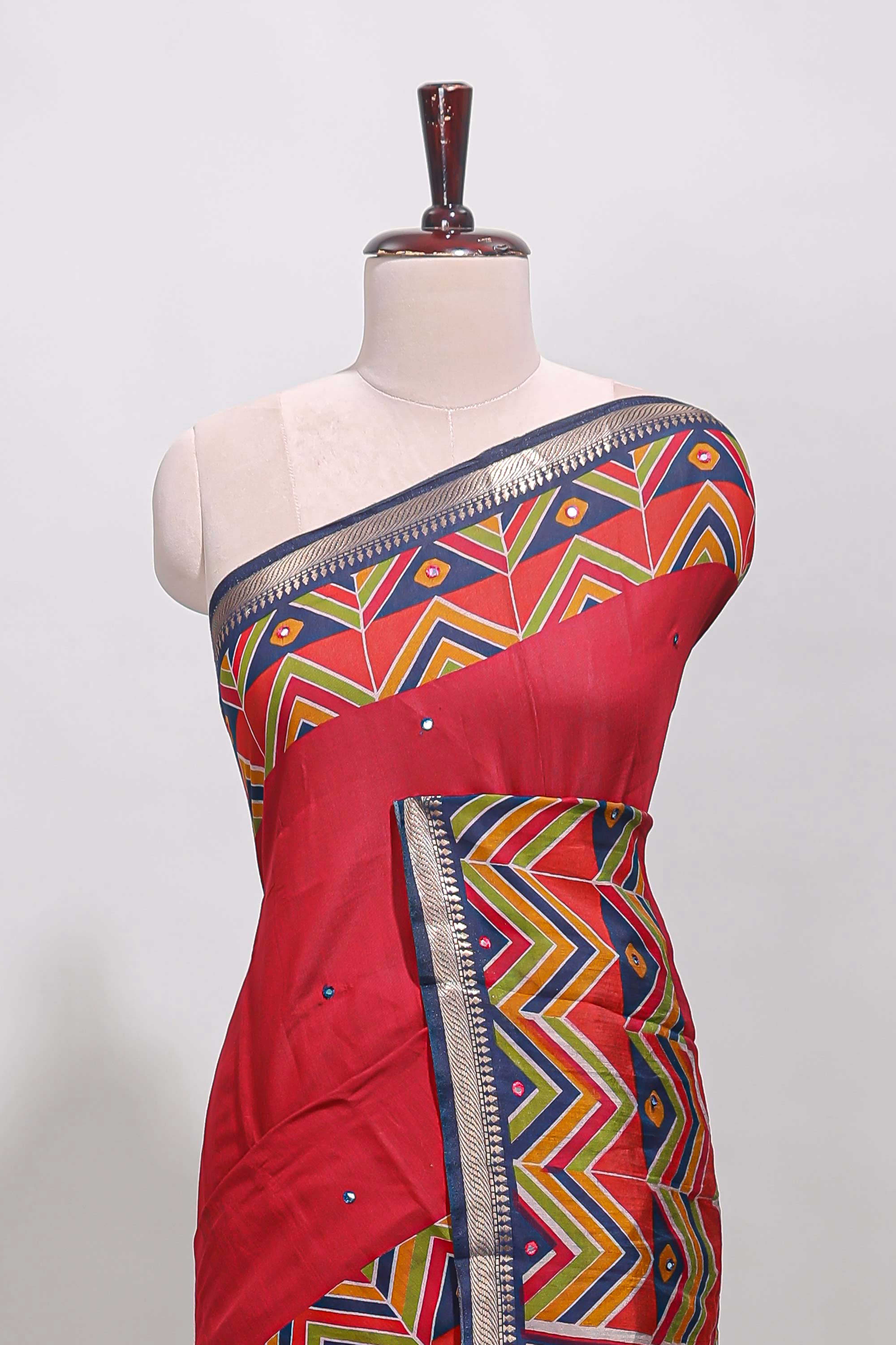 Red embroidery mirror work viscose georgette saree with contrast chevron design zari border and printed pallu