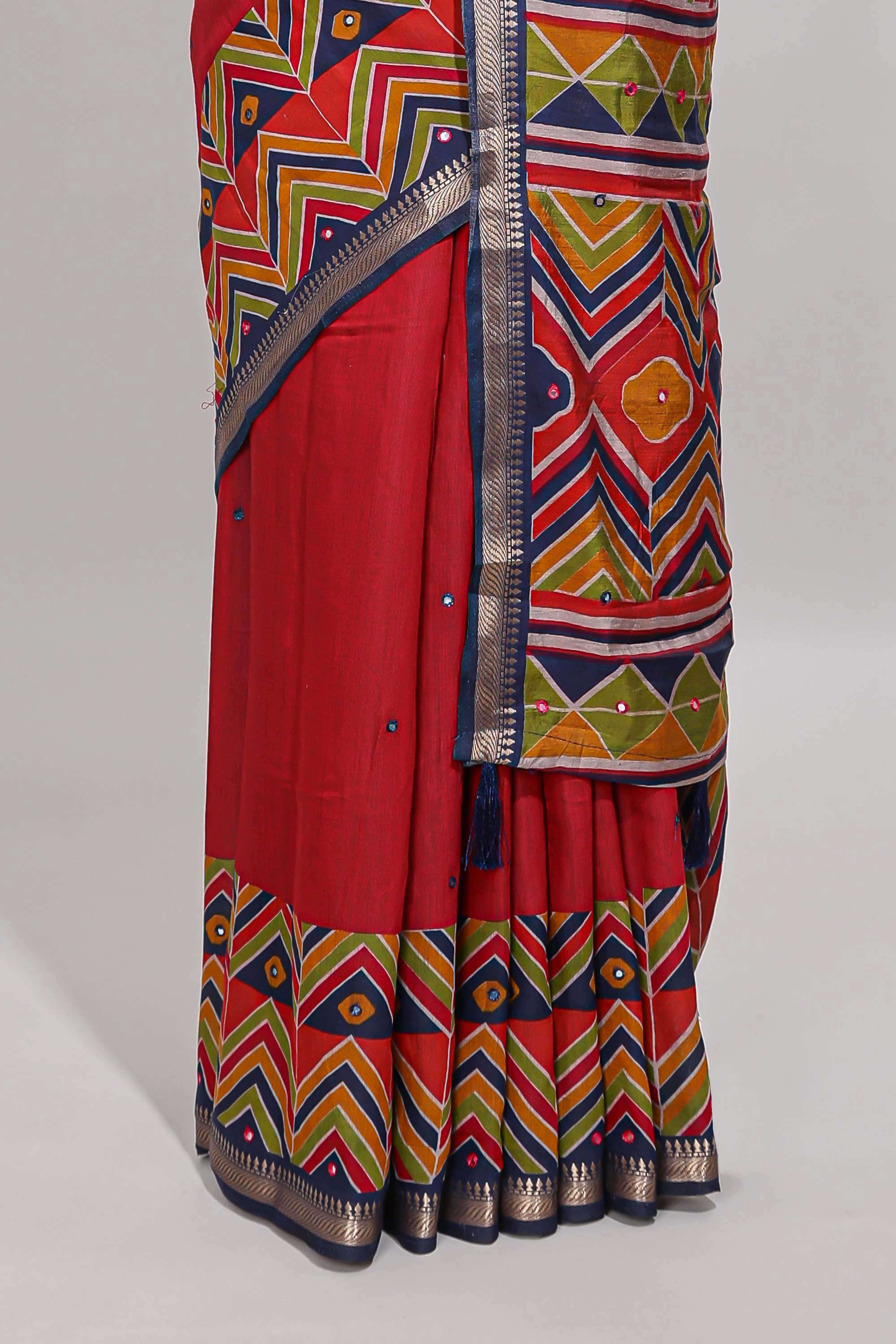 Red embroidery mirror work viscose georgette saree with contrast chevron design zari border and printed pallu