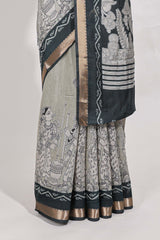 Grey colour viscose georgette saree All-over elegant ethnic detailing gold zari border and Statement pallu with artistic motifs with contrast printed blouse