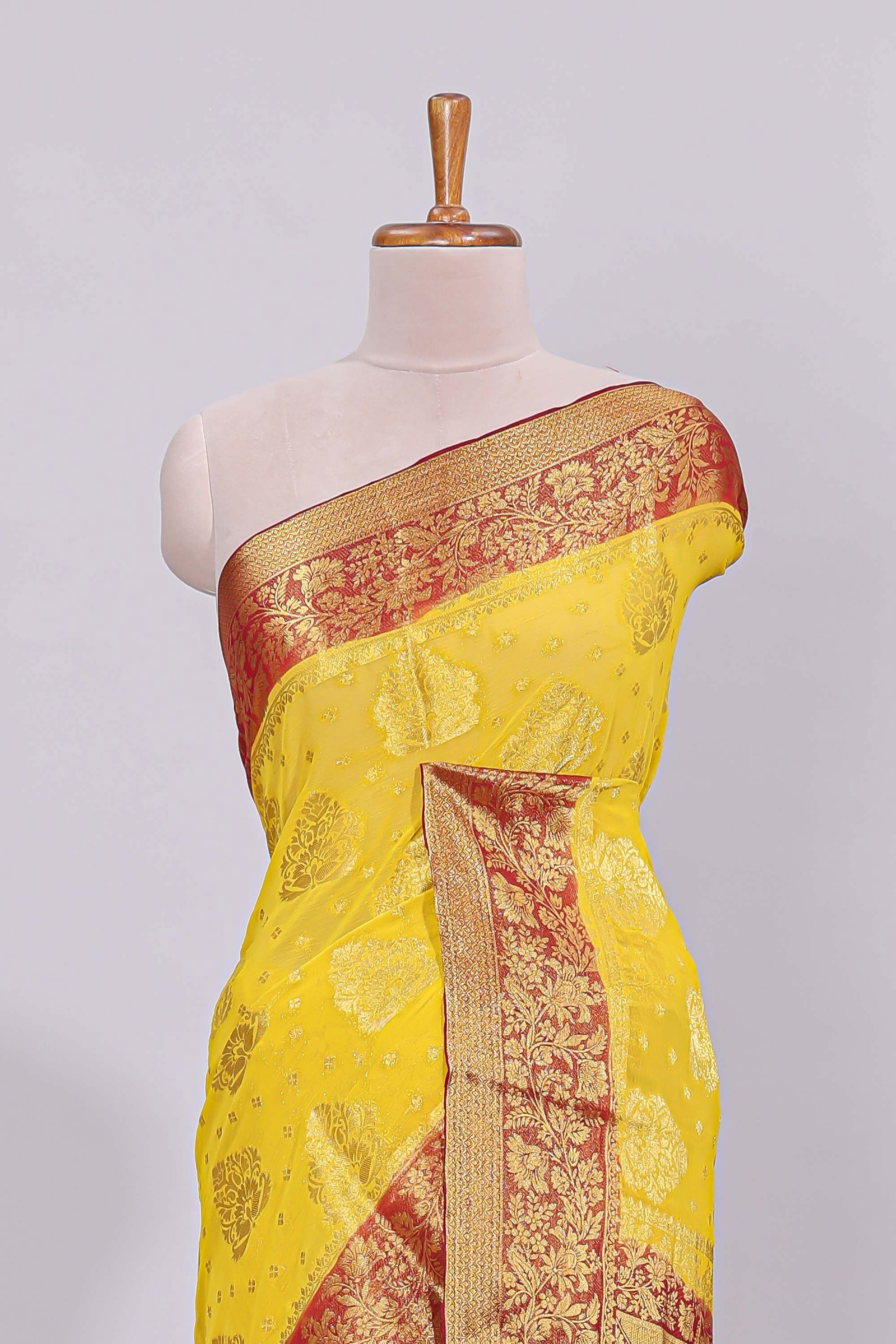 Yellow floral zari motifs viscose georgette saree with contrast checked zari border and blouse