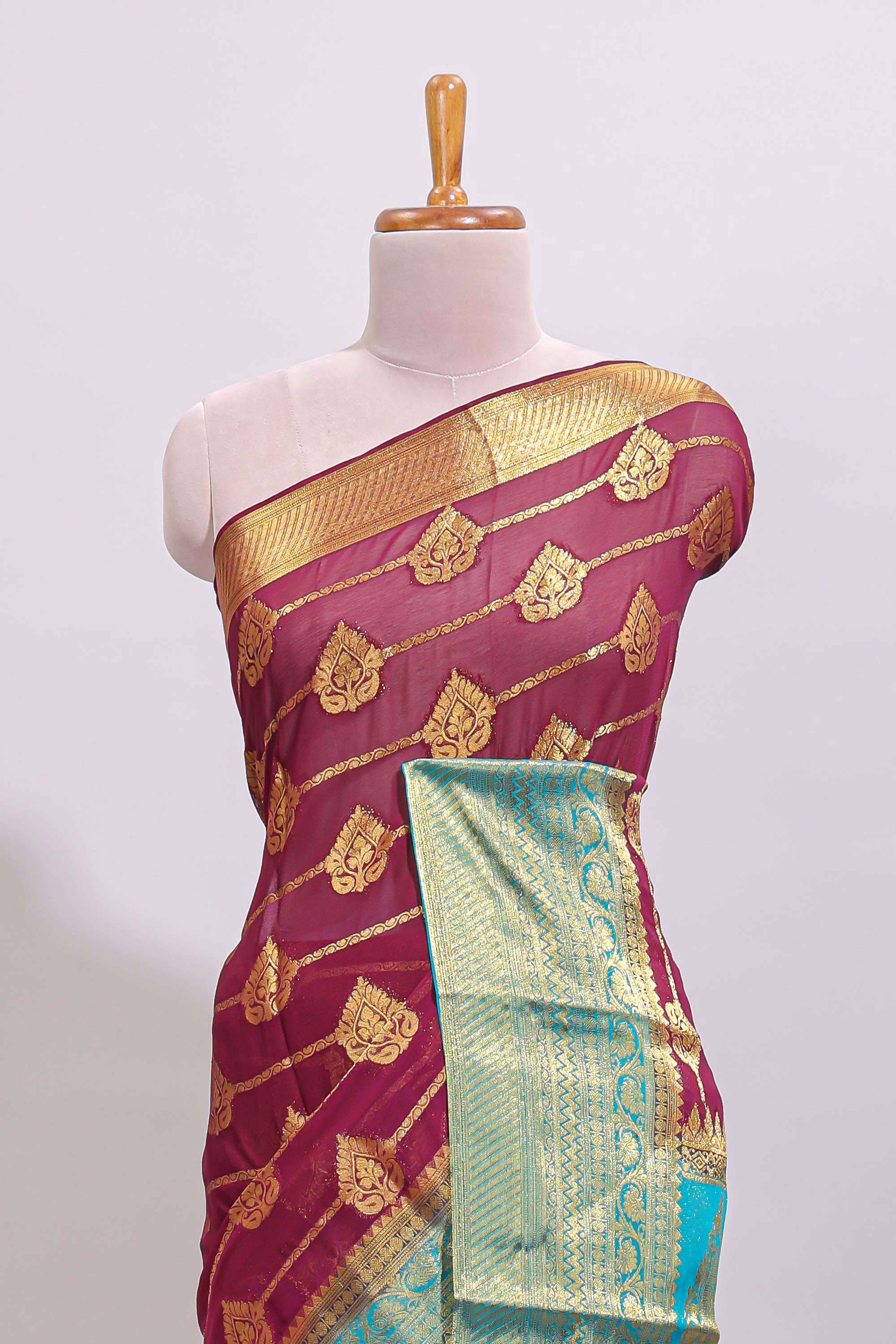 Maroon paisley zari design viscose georgette saree with contrast zari border and blouse