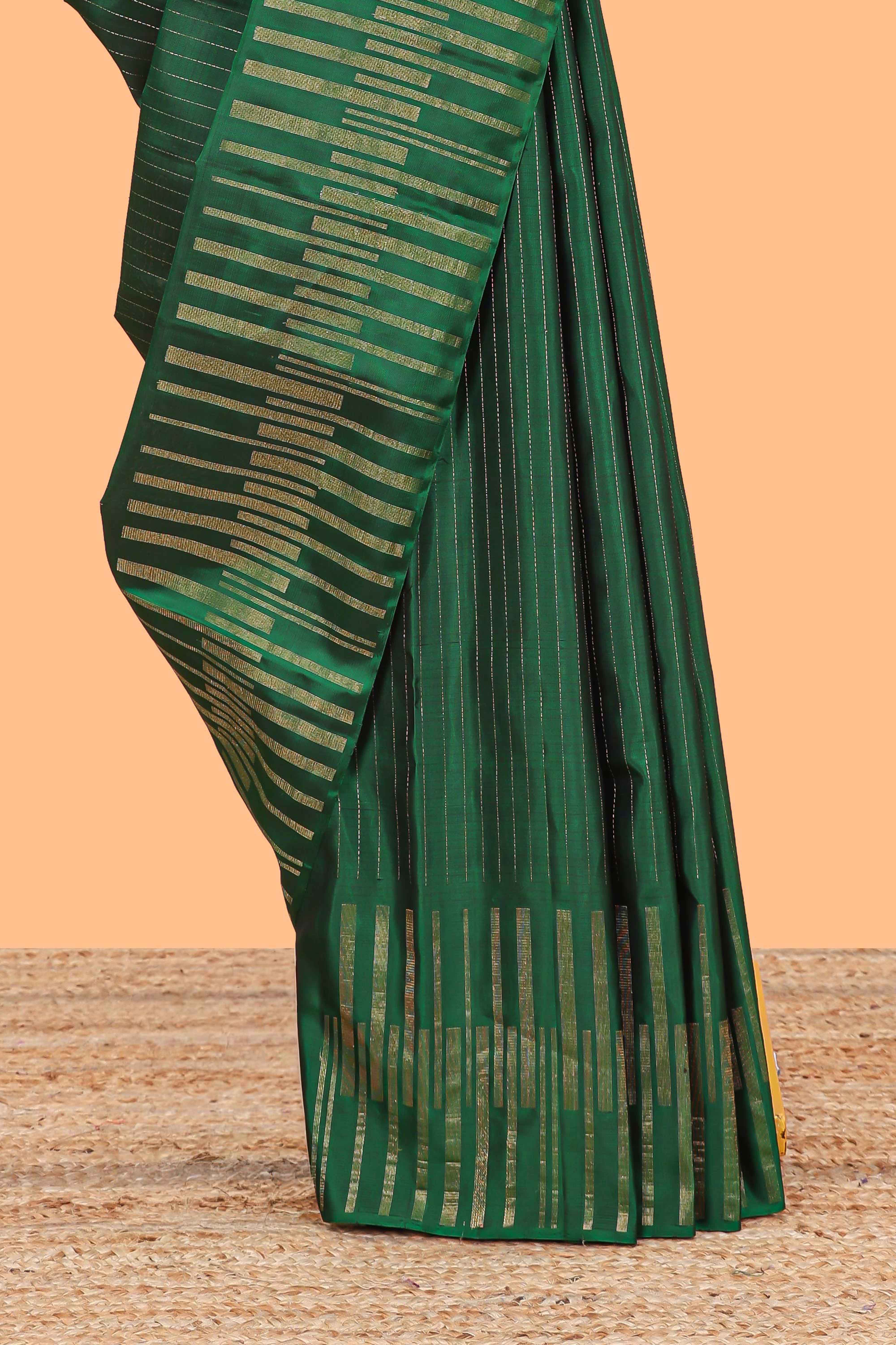 Borderless green parambariya pattu saree with zari stripes and matching checked zari pallu
