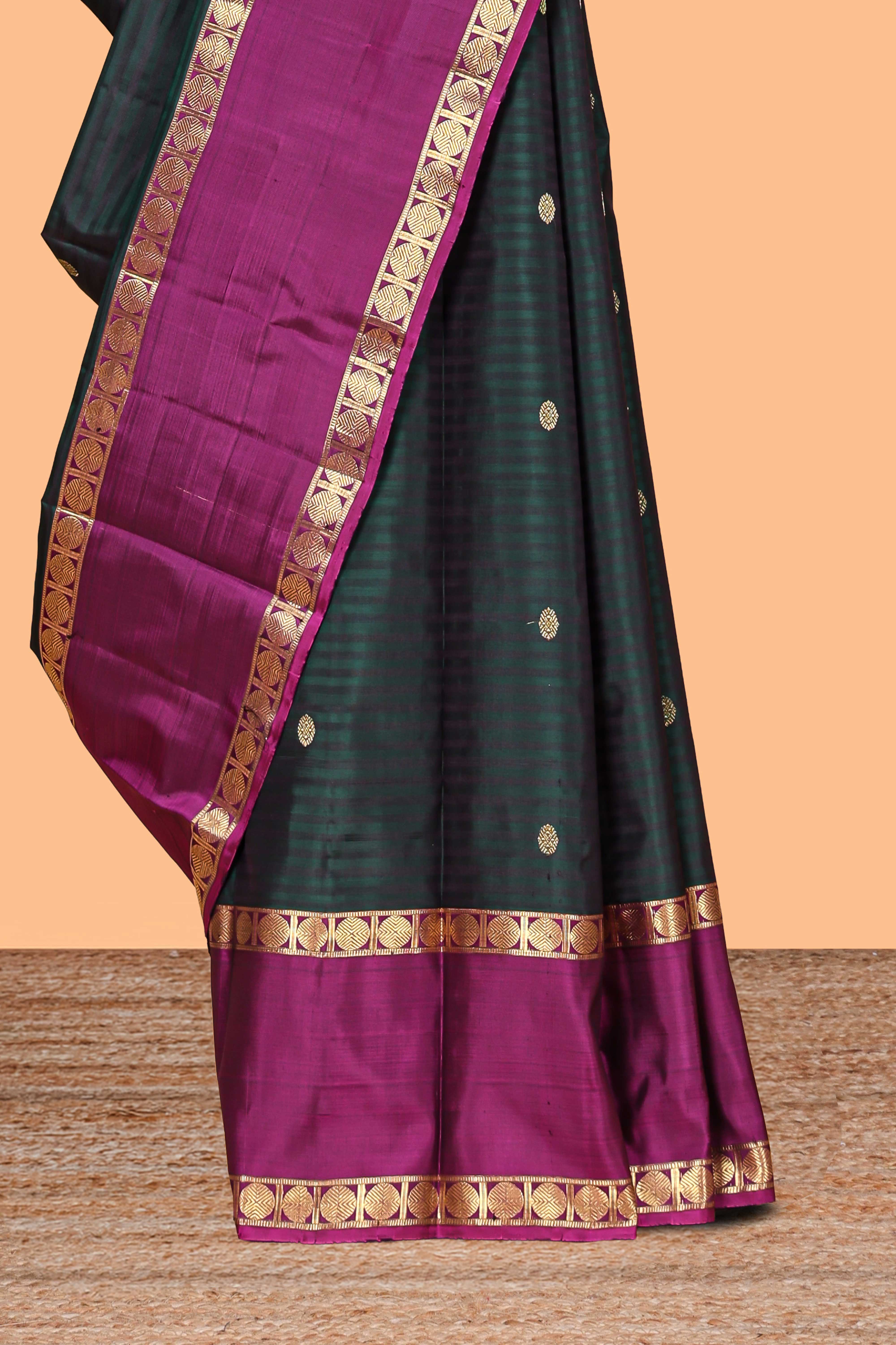 Dark green striped zari motifs parambariya pattu saree with contrast zari border and blouse