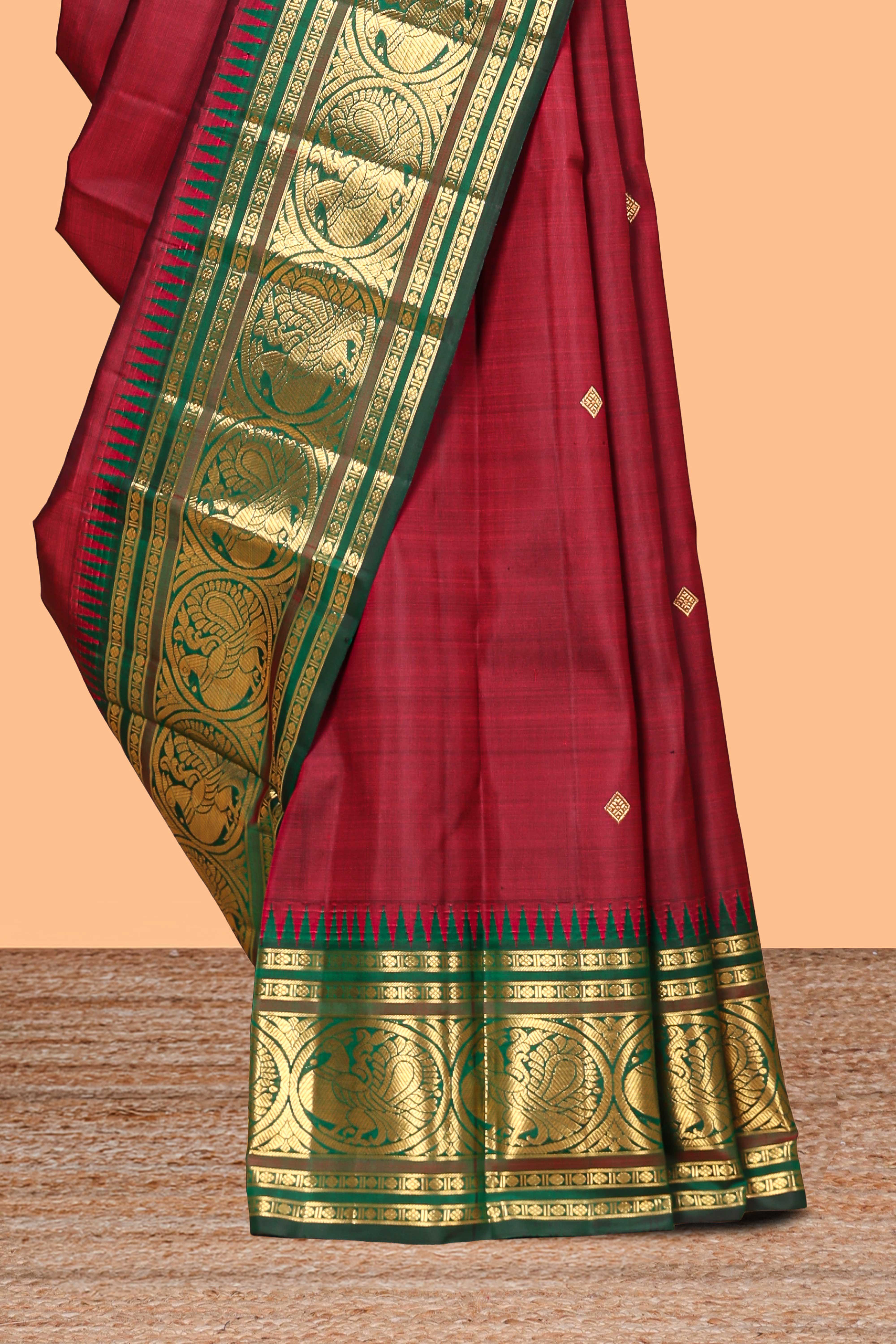 Maroon zari motifs parambariya pattu saree with contrast zari border and blouse