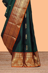 Bottle green floral design zari motifs parambariya pattu saree with contrast zari border and contrast blouse